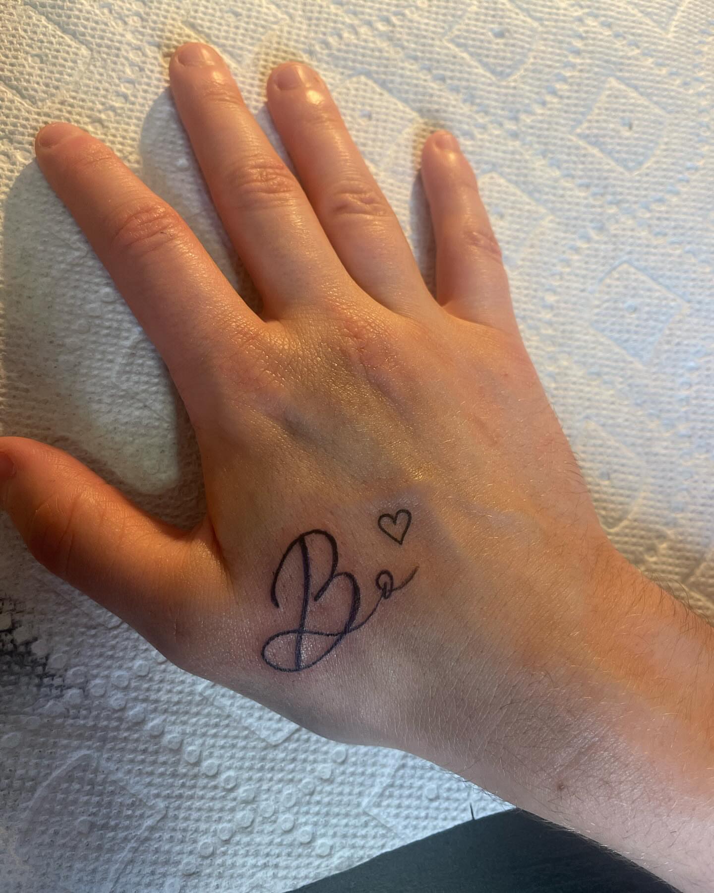 Be lettering script tattoo on the hand by Danny Garcia