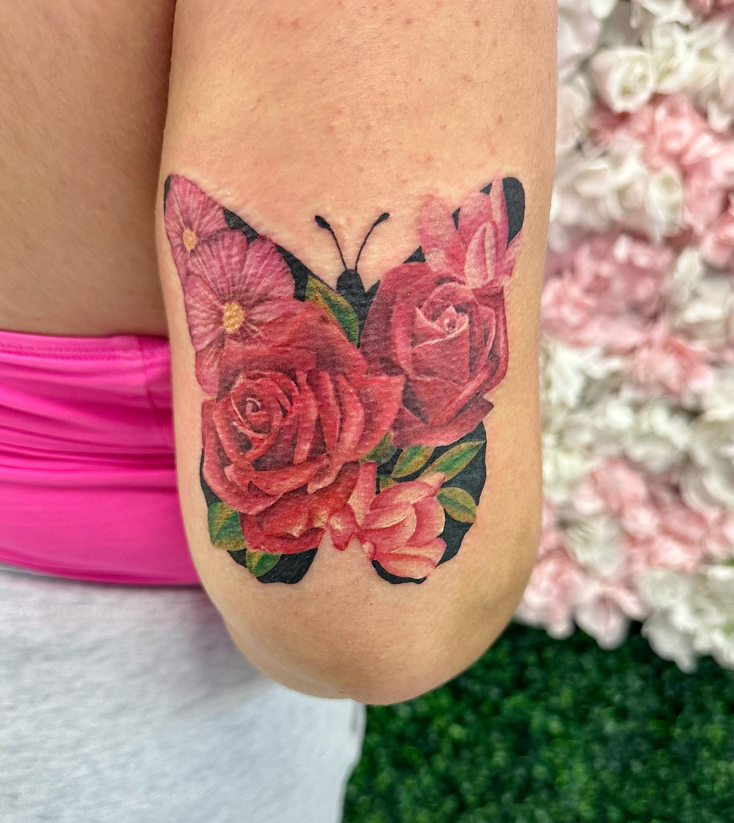 Roses and butterfly realism tattoo on the forearm by Erika Nambo