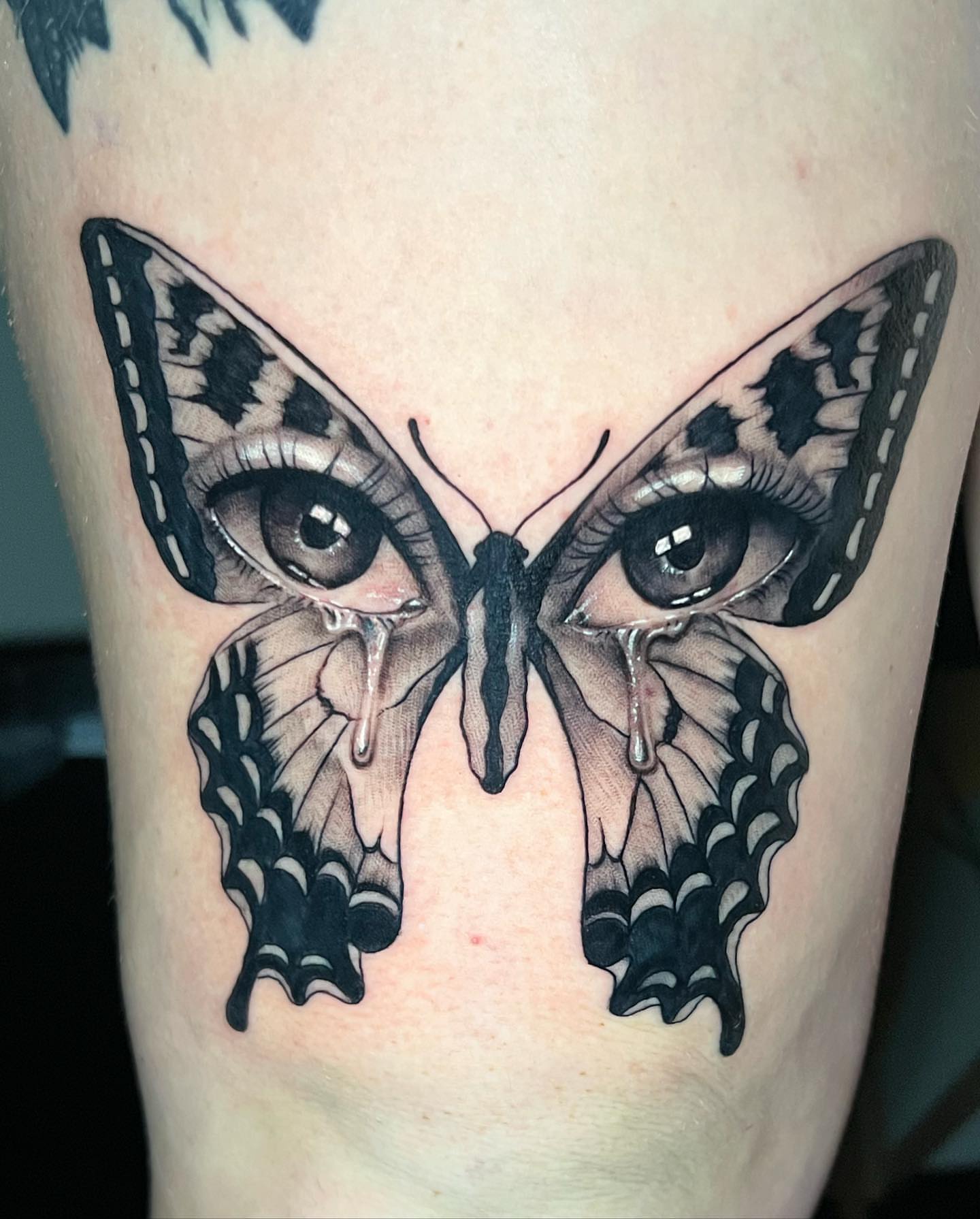 Butterfly eyes realism tattoo on the thigh by Matthew Arguello