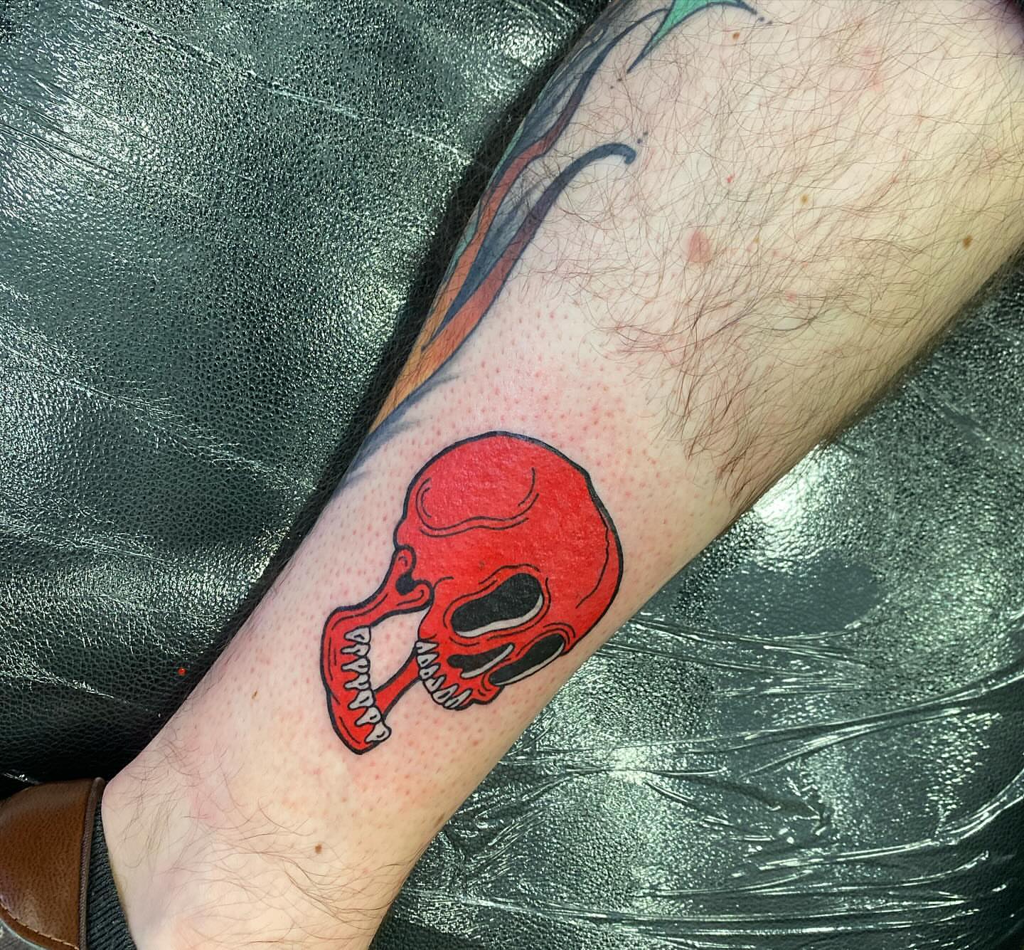 Red skull American traditional tattoo on the forearm by S C O T T