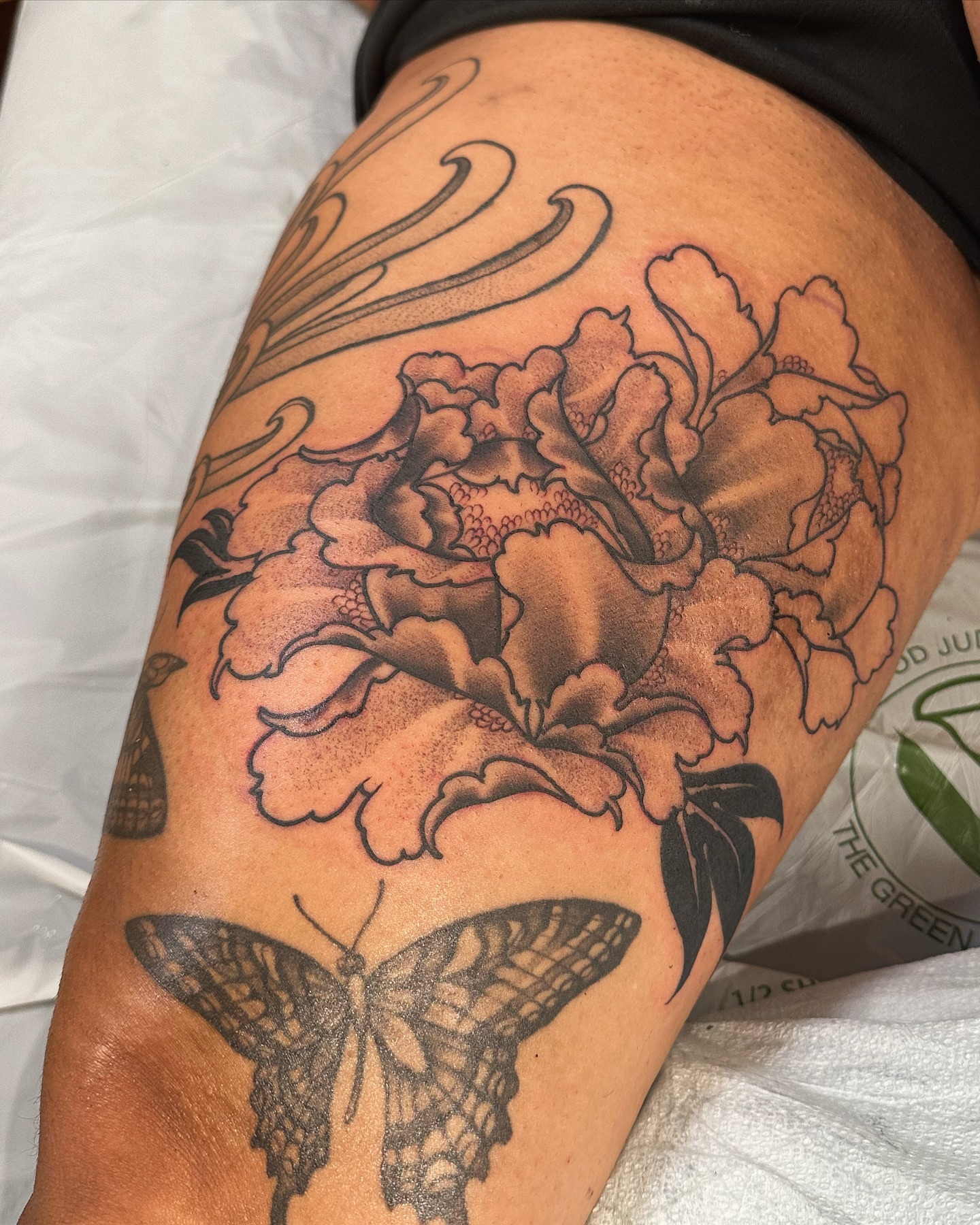 Peony and butterfly black and grey tattoo on the thigh by abigail 🌸