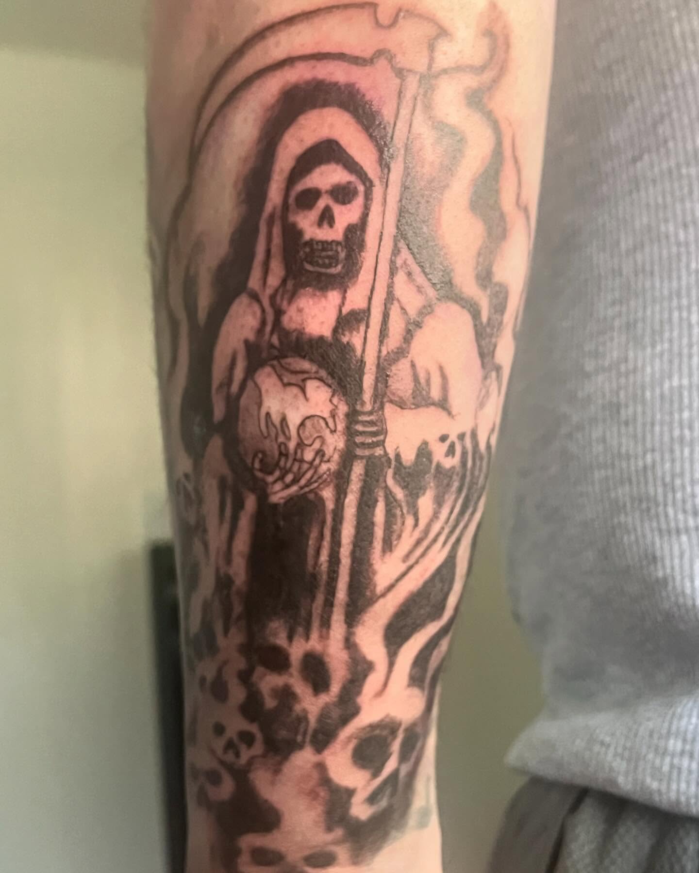 Reaper black and grey tattoo on the forearm by Ink_ Hustle36
