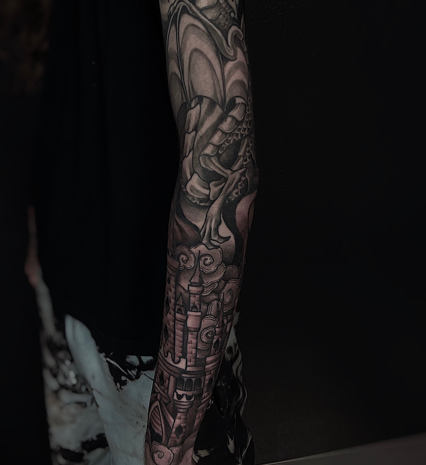 Dragon and castle realism tattoo on the forearm by Kolby