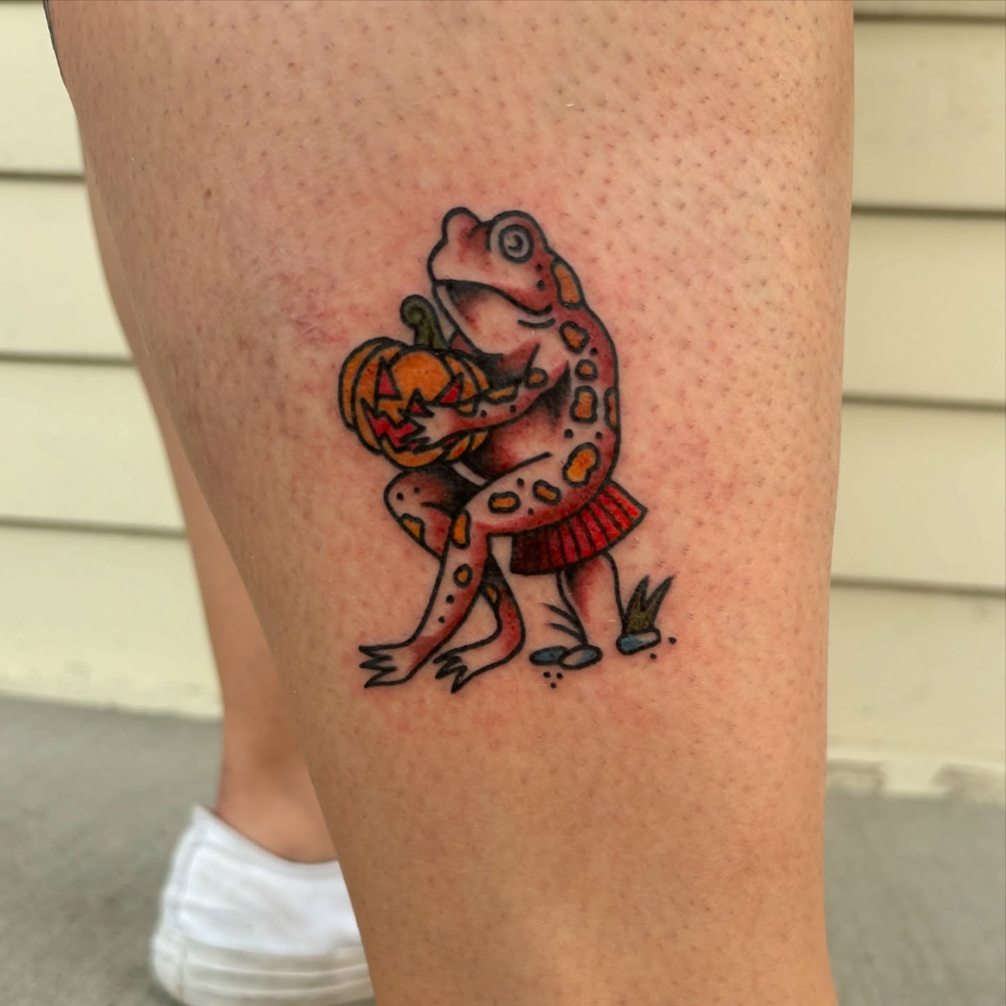 Frog with pumpkin dotwork tattoo on the thigh by Jordan Wray