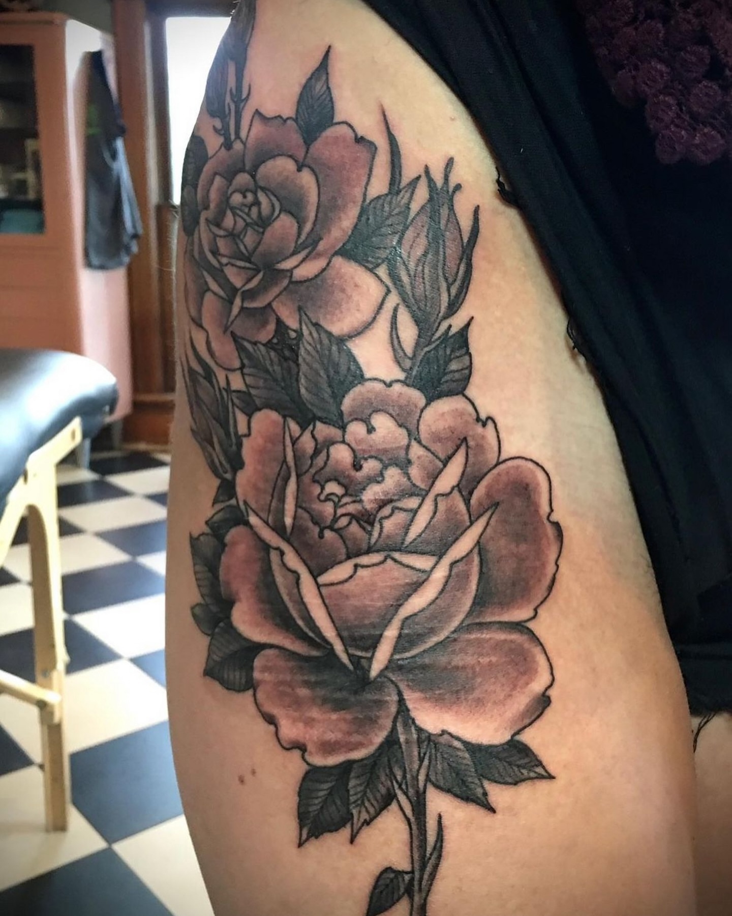 Roses American traditional tattoo on the thigh by Brian Hutflies