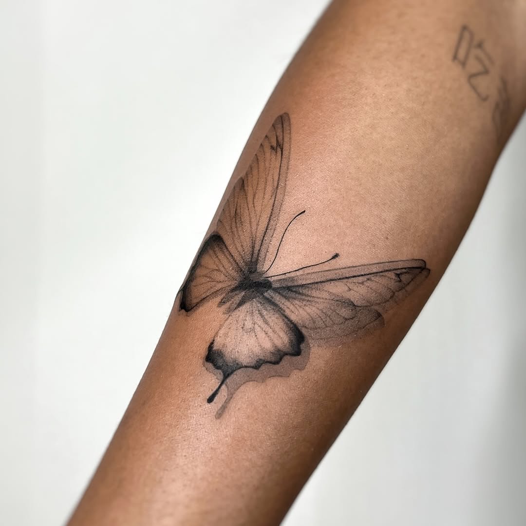Butterfly fine line tattoo on the forearm by tattoo artist