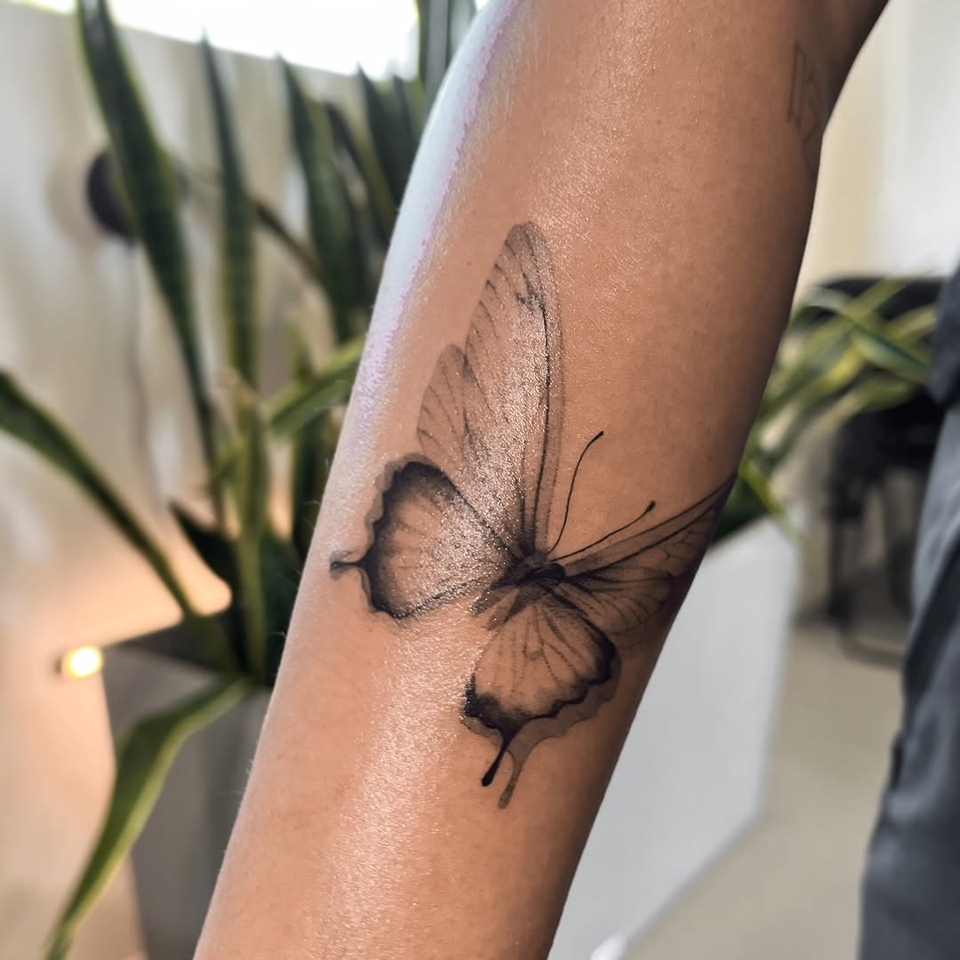 Butterfly fine line tattoo on the forearm by tattoo artist