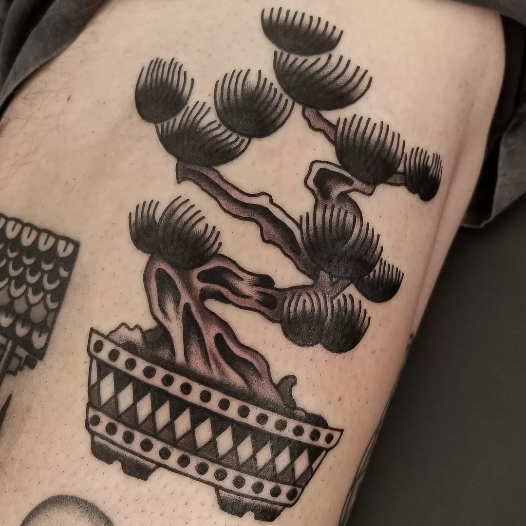 Bonsai tree black and grey tattoo on the thigh by Deke Harms, Bend, Oregon