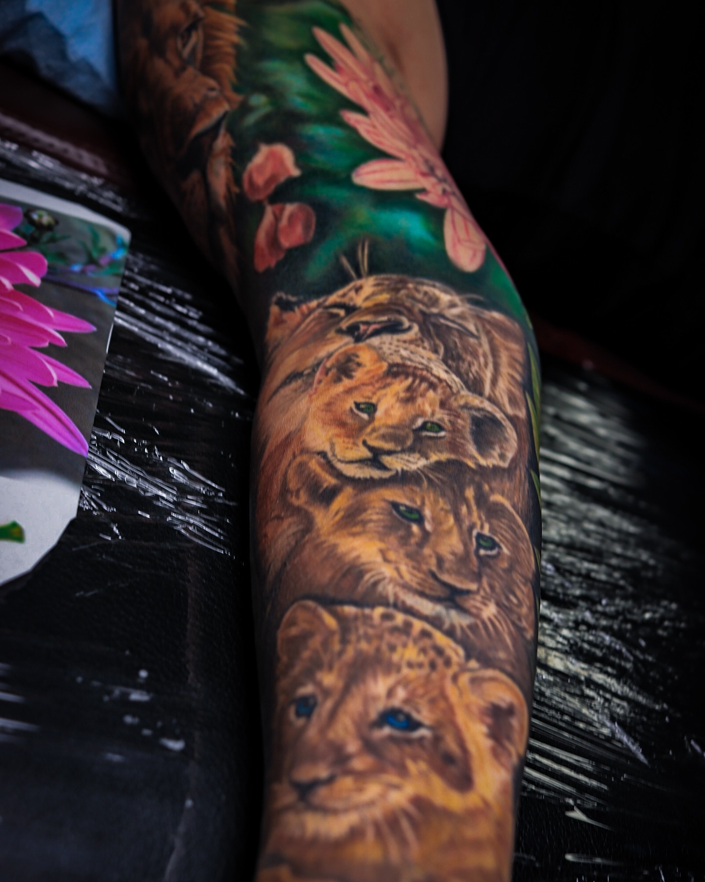 Lion family realism tattoo on the forearm by Gary Graves