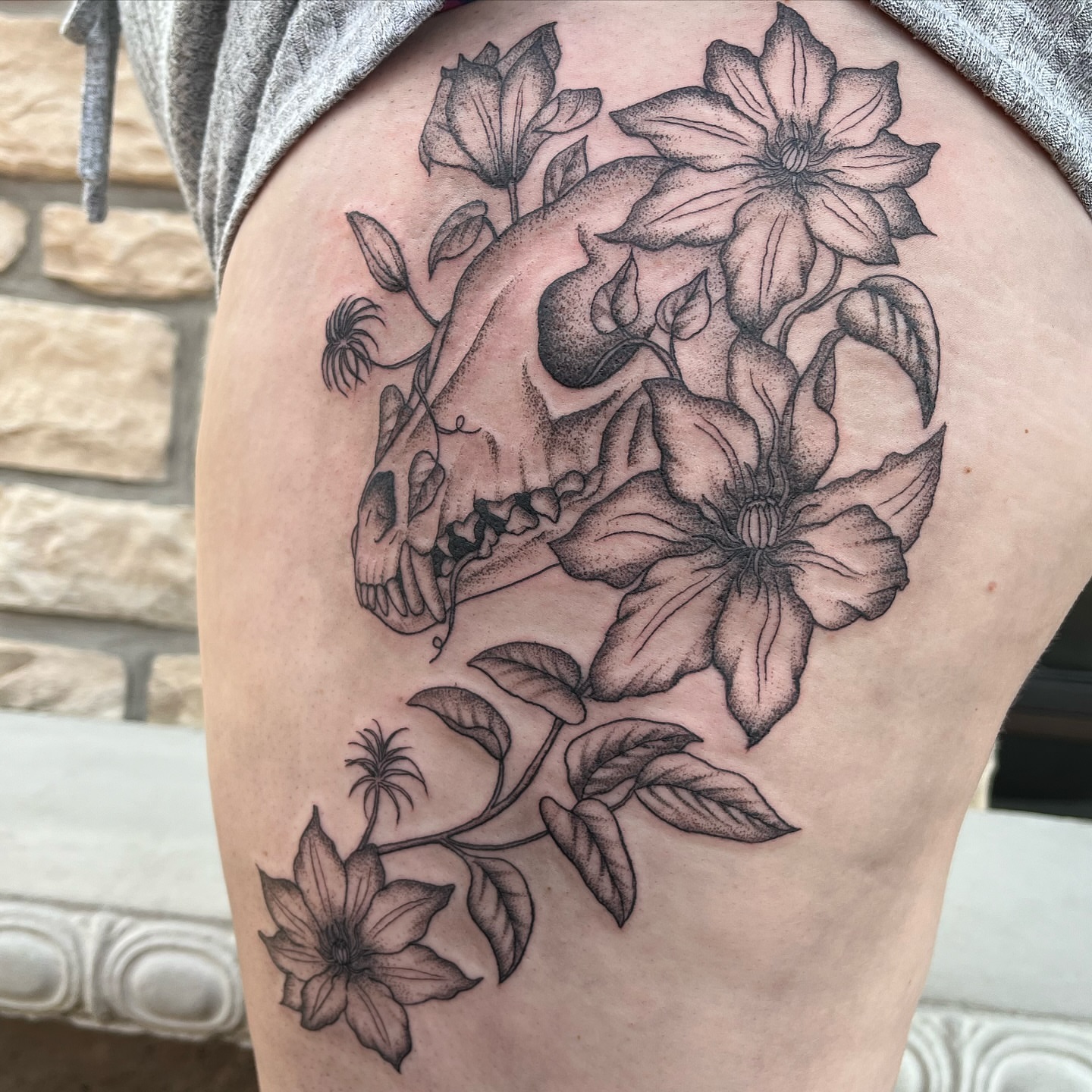 Skull and flowers dotwork tattoo on the thigh by Tina Petrullo, West Chester Township, Butler County, Ohio