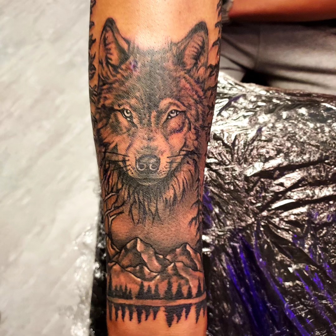 Wolf realism tattoo on the forearm by Dave Johnson, Billings, Montana