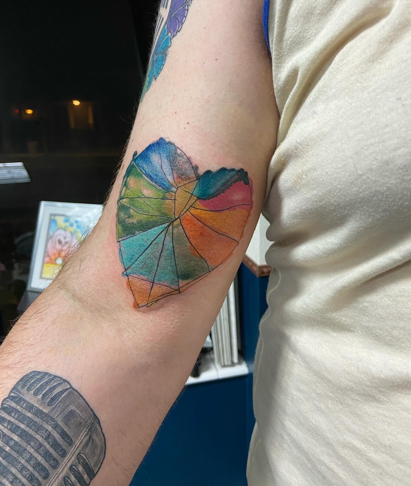 Umbrella watercolor tattoo on the forearm by Robyn Mahon
