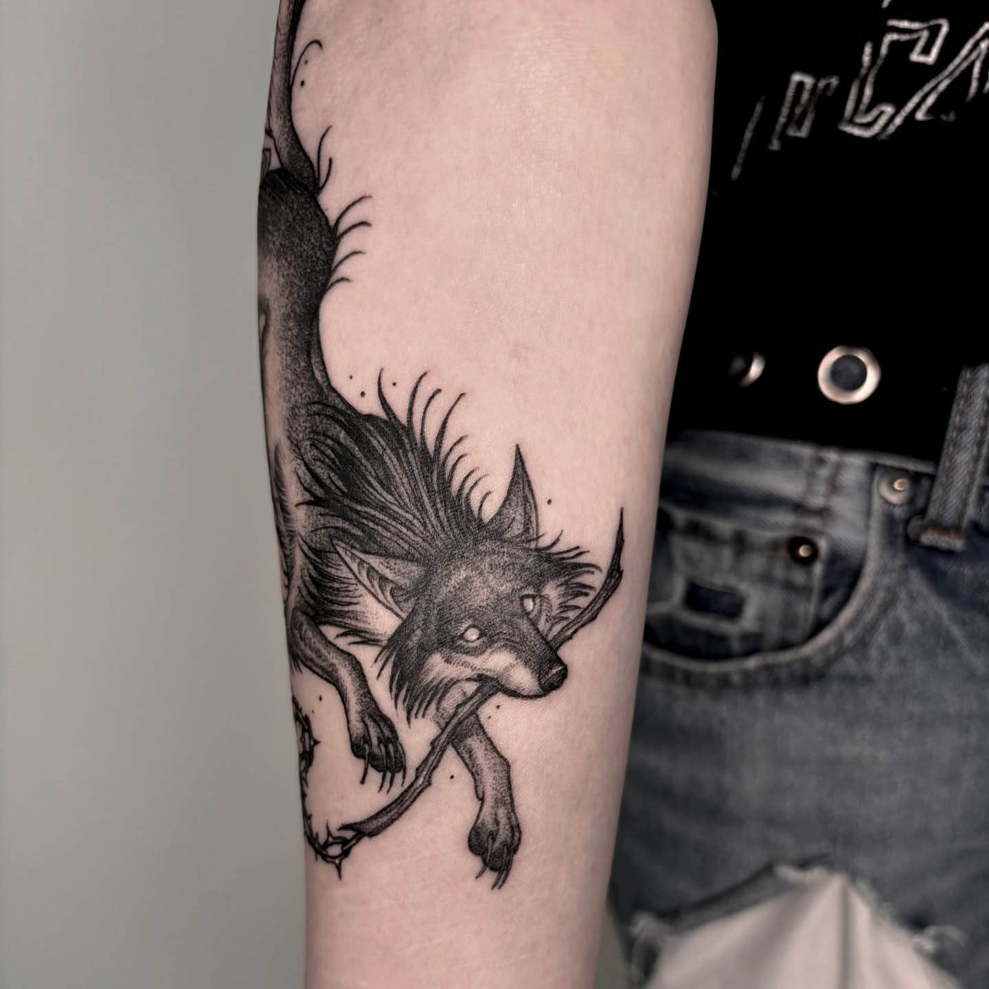 Wolf black and grey tattoo on the forearm by Jens