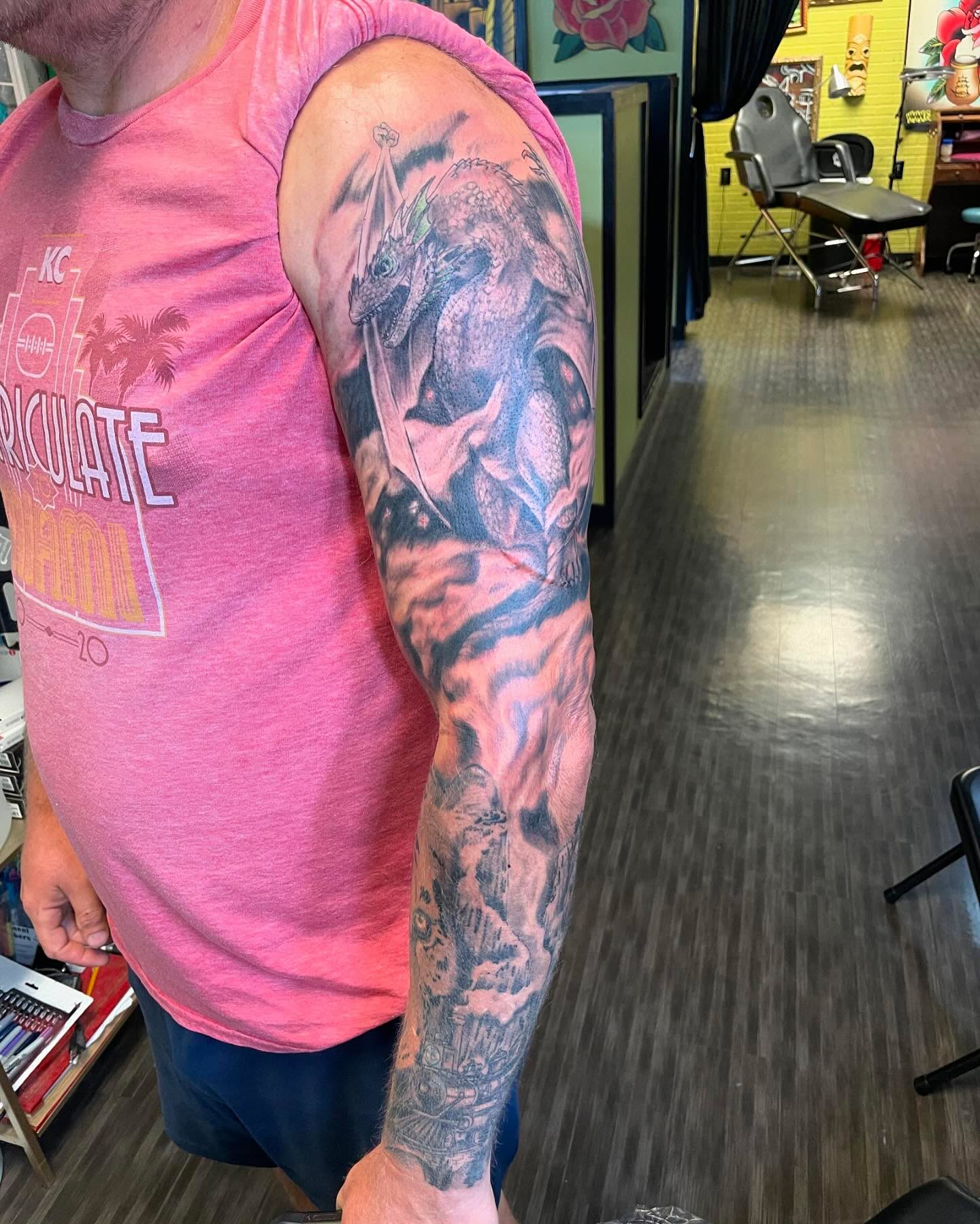 Dragon realism tattoo on the upper arm by Evan