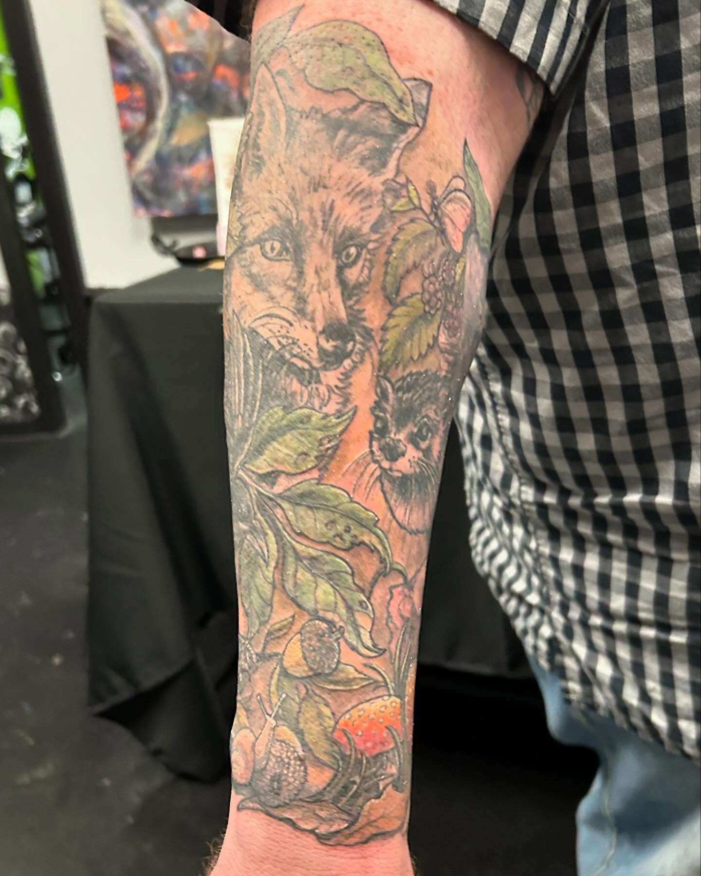 Fox and raccoon realism tattoo on the forearm by B Hendrix, Cuyahoga Falls, Ohio