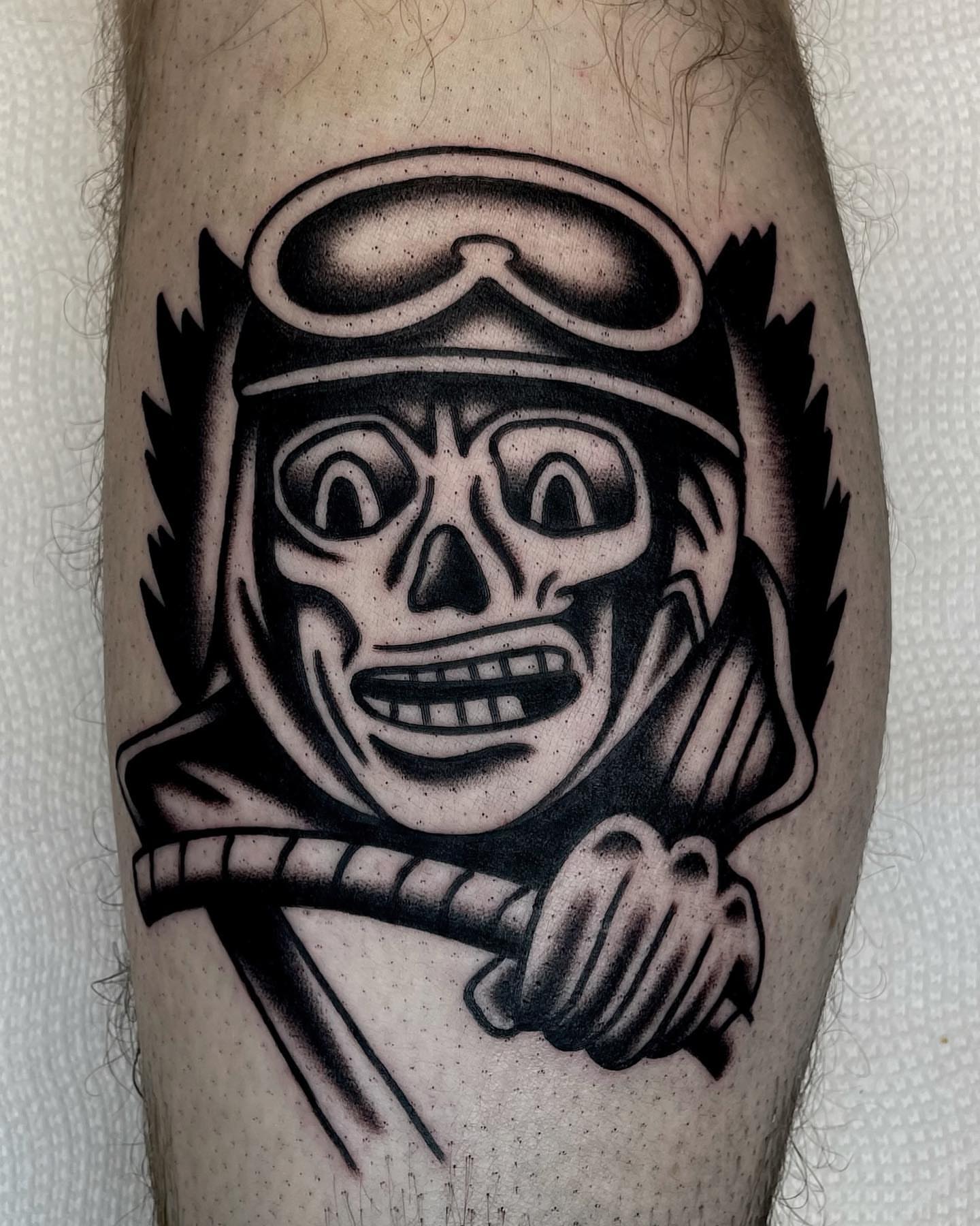 Skull wearing helmet black and grey tattoo on the forearm by Jenn ★ Reid