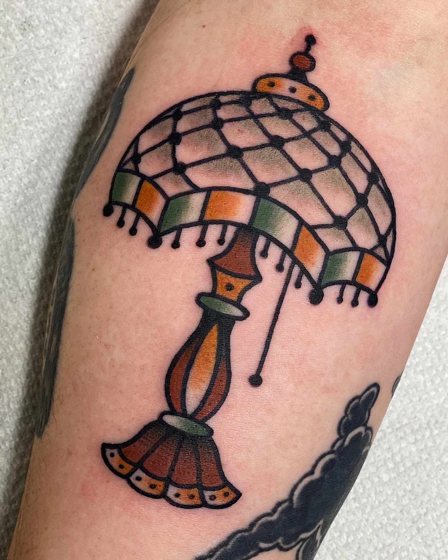 Umbrella American traditional tattoo on the forearm by Dakota Amato