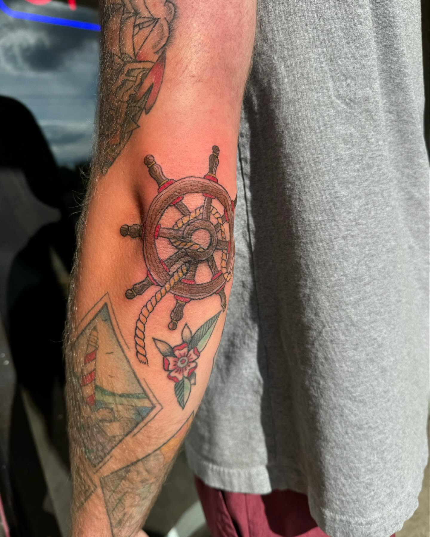 Ship's wheel American traditional tattoo on the forearm by Marissa Losier