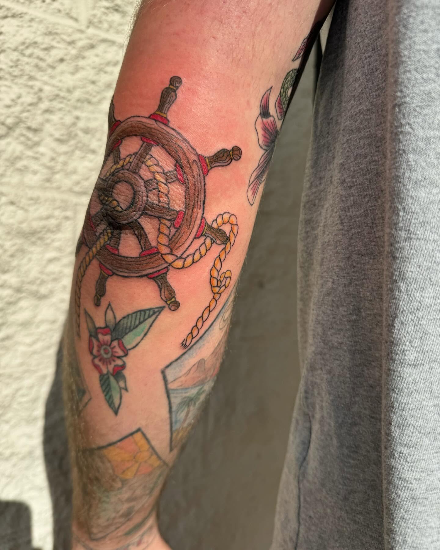 Ship wheel and rope American traditional tattoo on the forearm by Marissa Losier