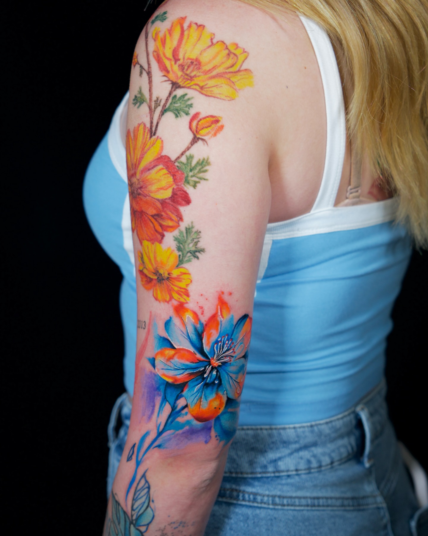 Floral bouquet watercolor tattoo on the upper arm by Keyla Valdes, Miami, Florida