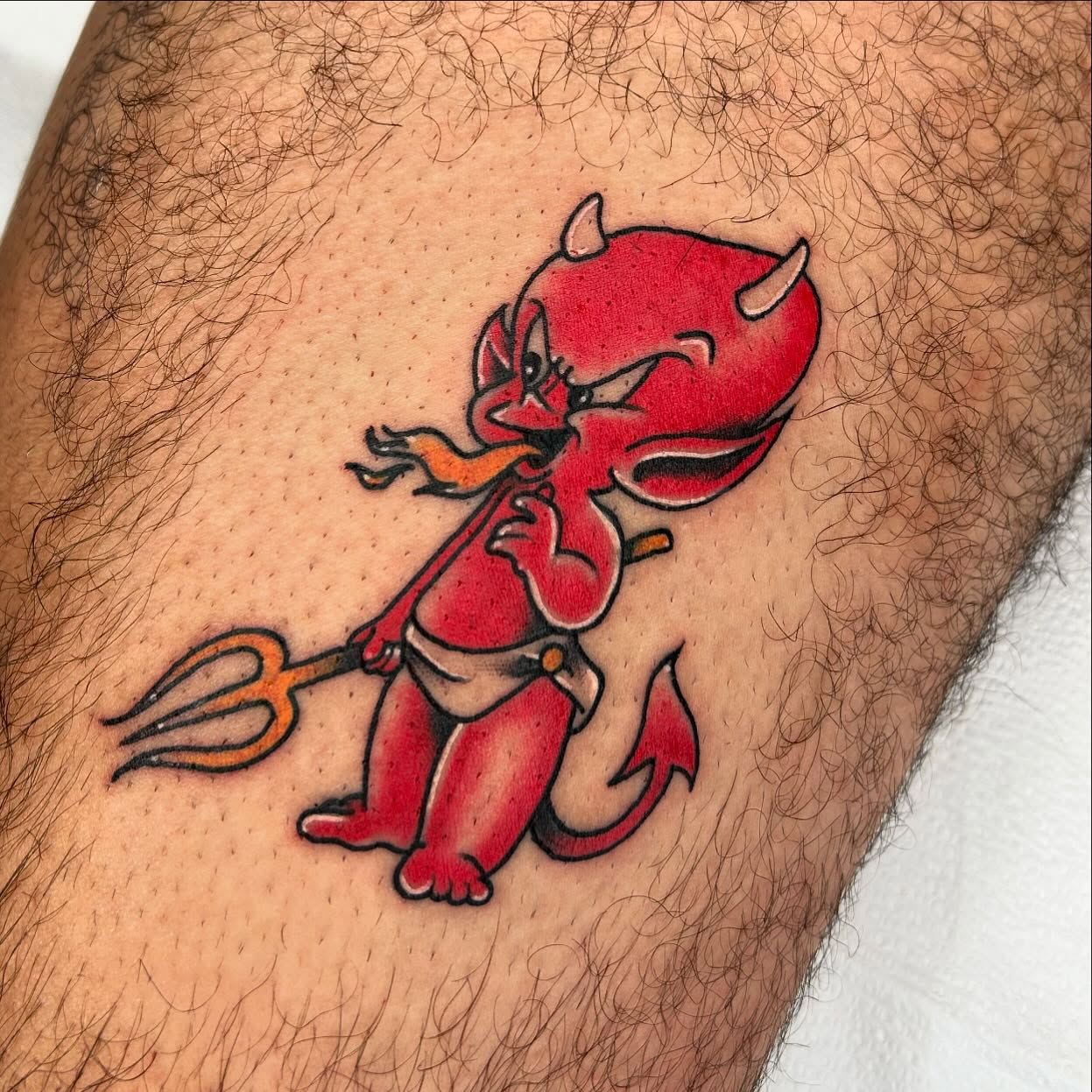 Red devil new school tattoo on the thigh by Noah Crow