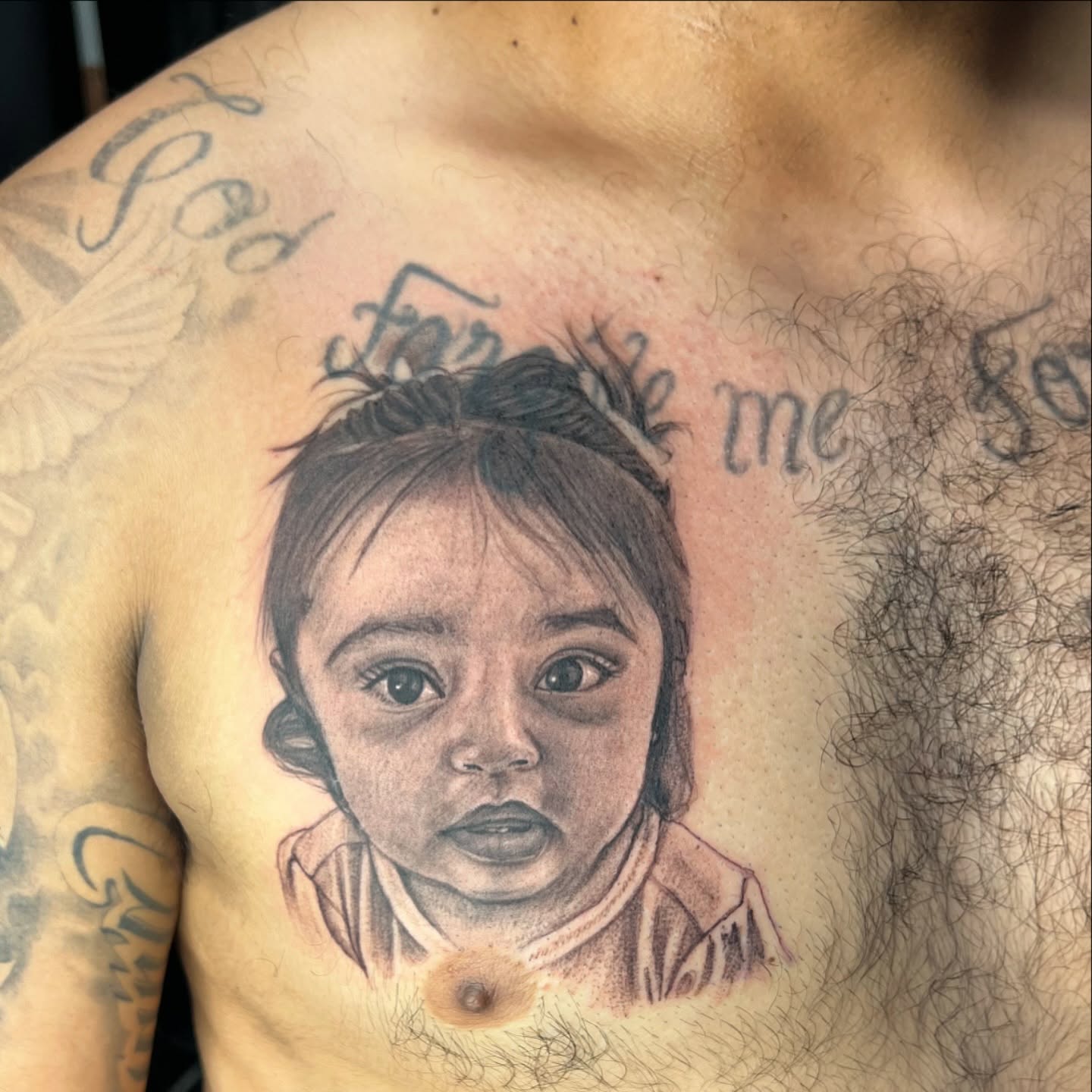 Child portrait realism tattoo on the chest by JT Ink