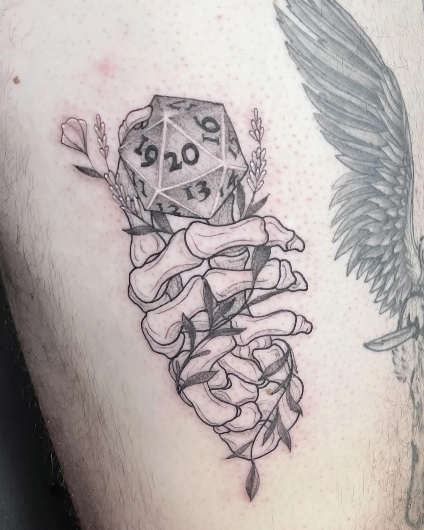 D20 and heart geometric tattoo on the thigh by Eric Axle