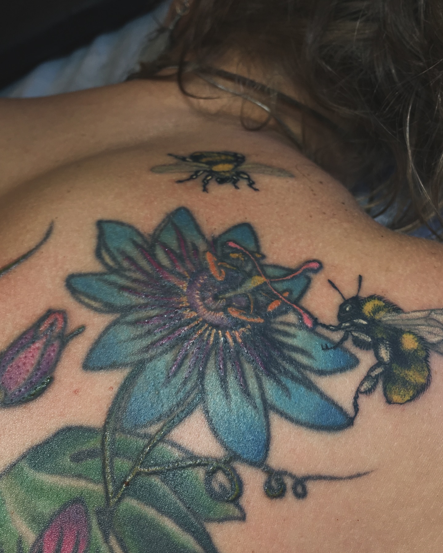 Passion flower and bees new school tattoo on the shoulder by Brian Hutflies