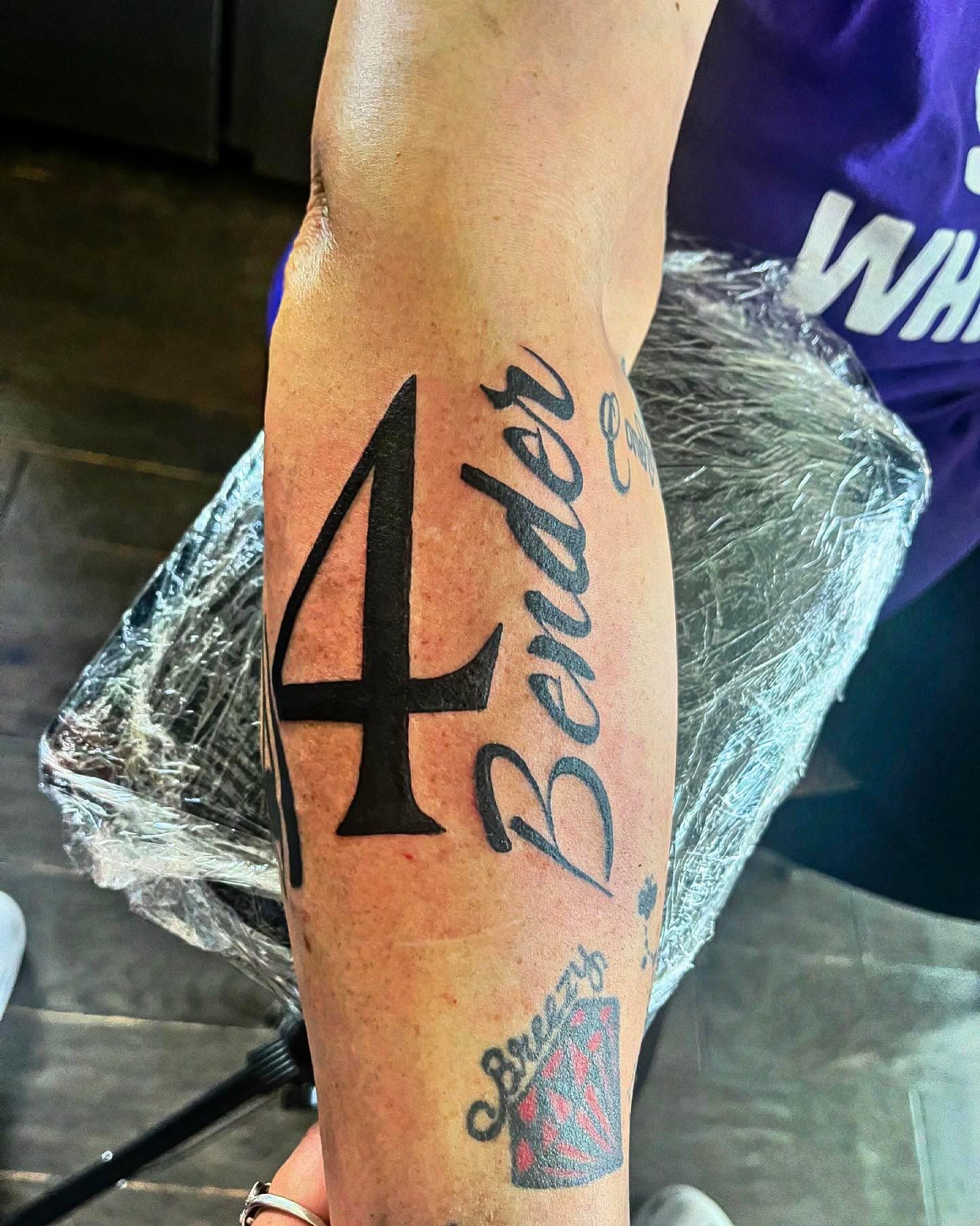 Number 4 and cursive text lettering script tattoo on the forearm by Anna DeLuna