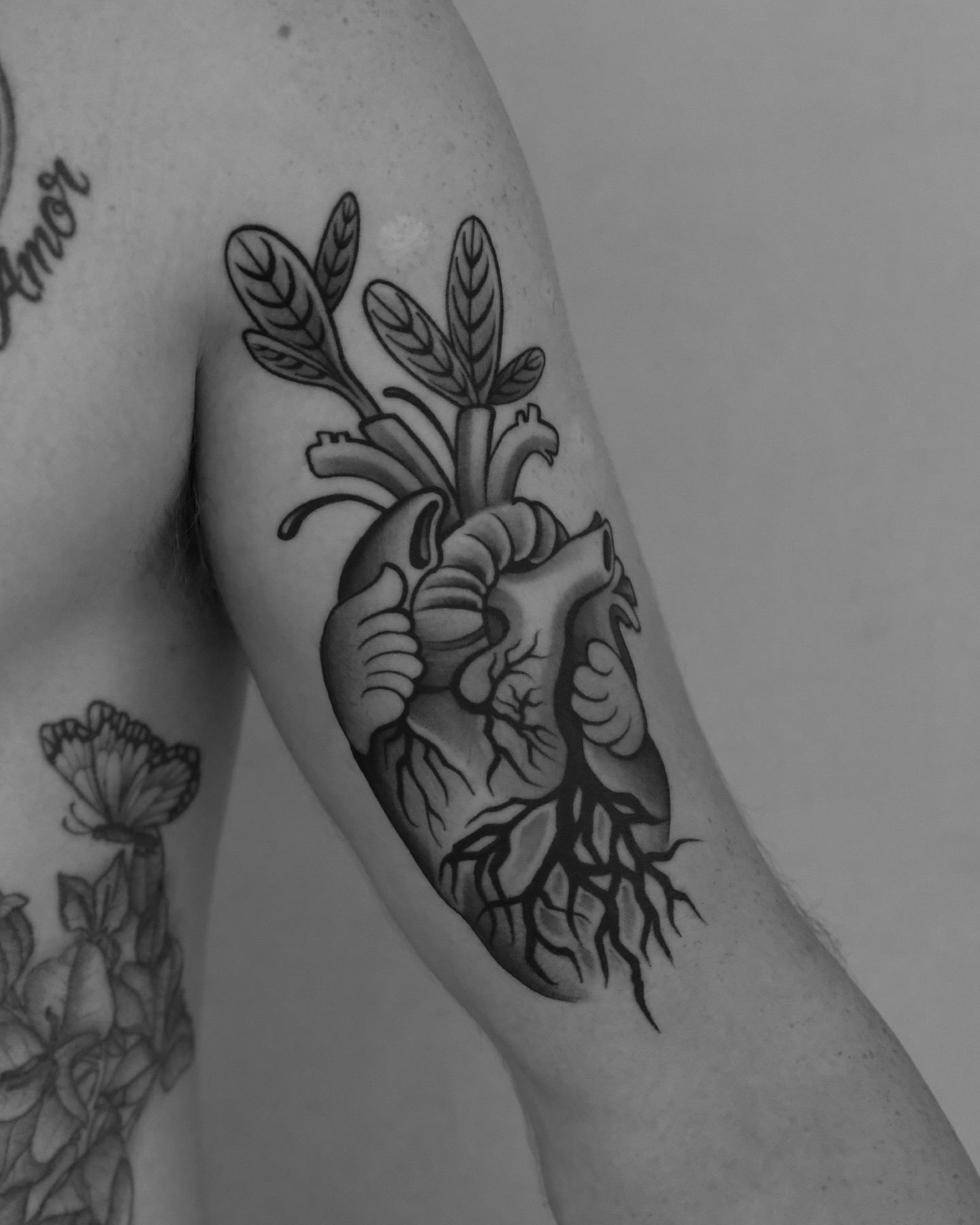 Heart with plant black and grey tattoo on the forearm by ๐ฃ๐๐๐ ๐๐ ๐ฆ๐๐๐ฉ๐