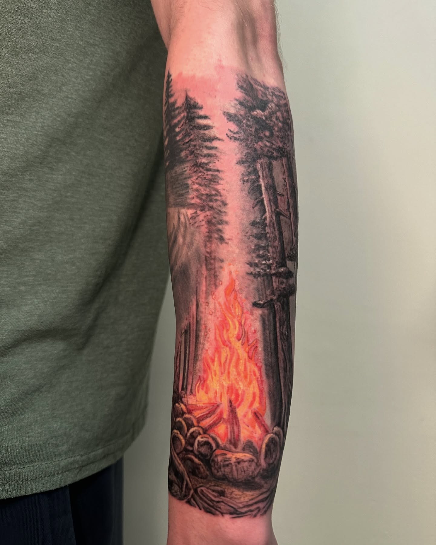 Forest fire realism tattoo on the forearm by Héctor Agudelo