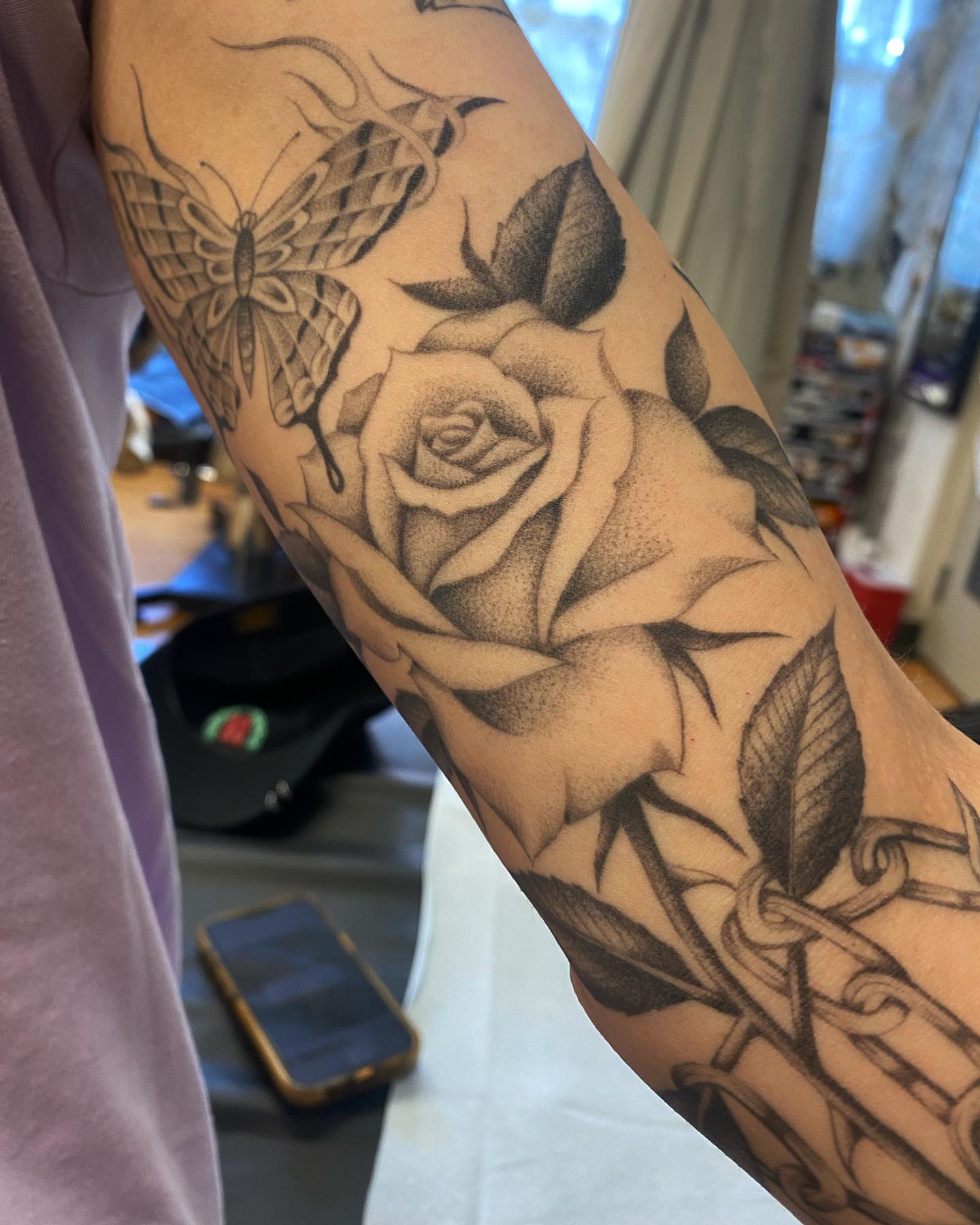 Rose and butterfly dotwork tattoo on the forearm by Alan Pham, San Jose, California