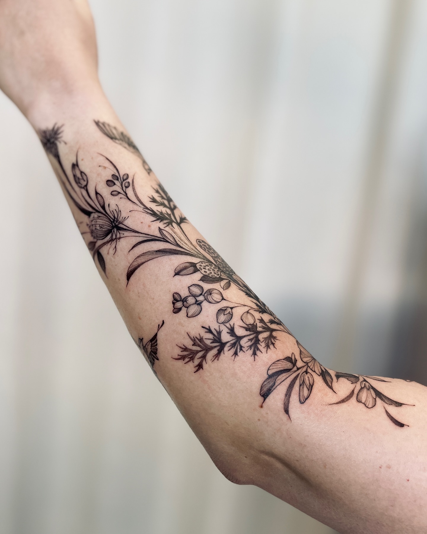 Floral design black and grey tattoo on the forearm by Dung Ngo