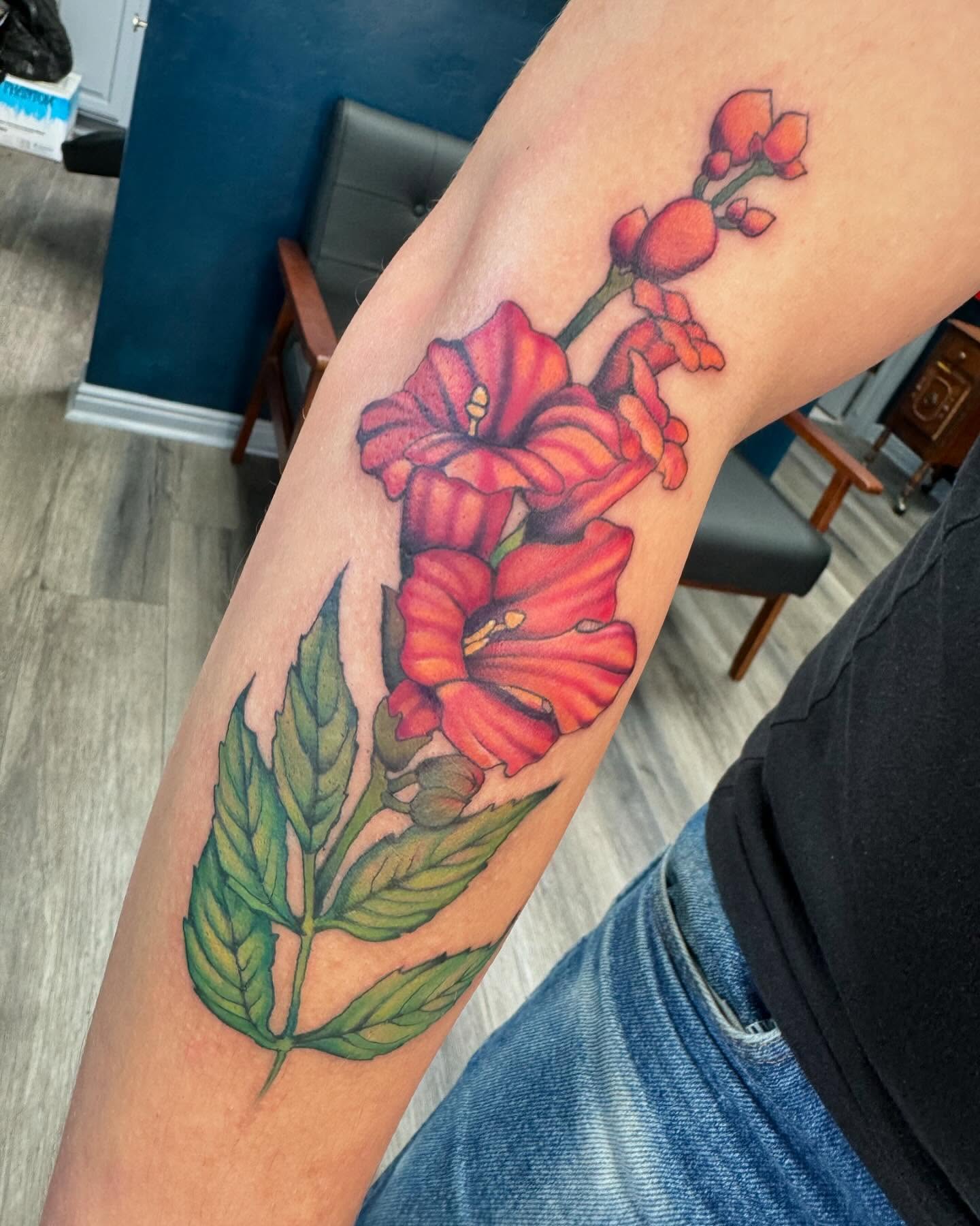 Gladiolus flowers realism tattoo on the forearm by Robyn Mahon