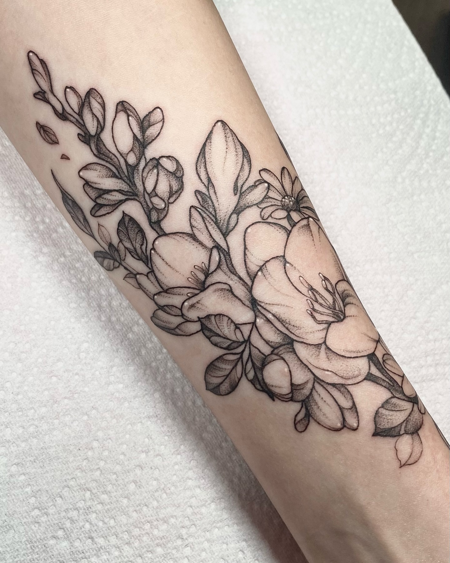 Floral arrangement realism tattoo on the forearm by IVY