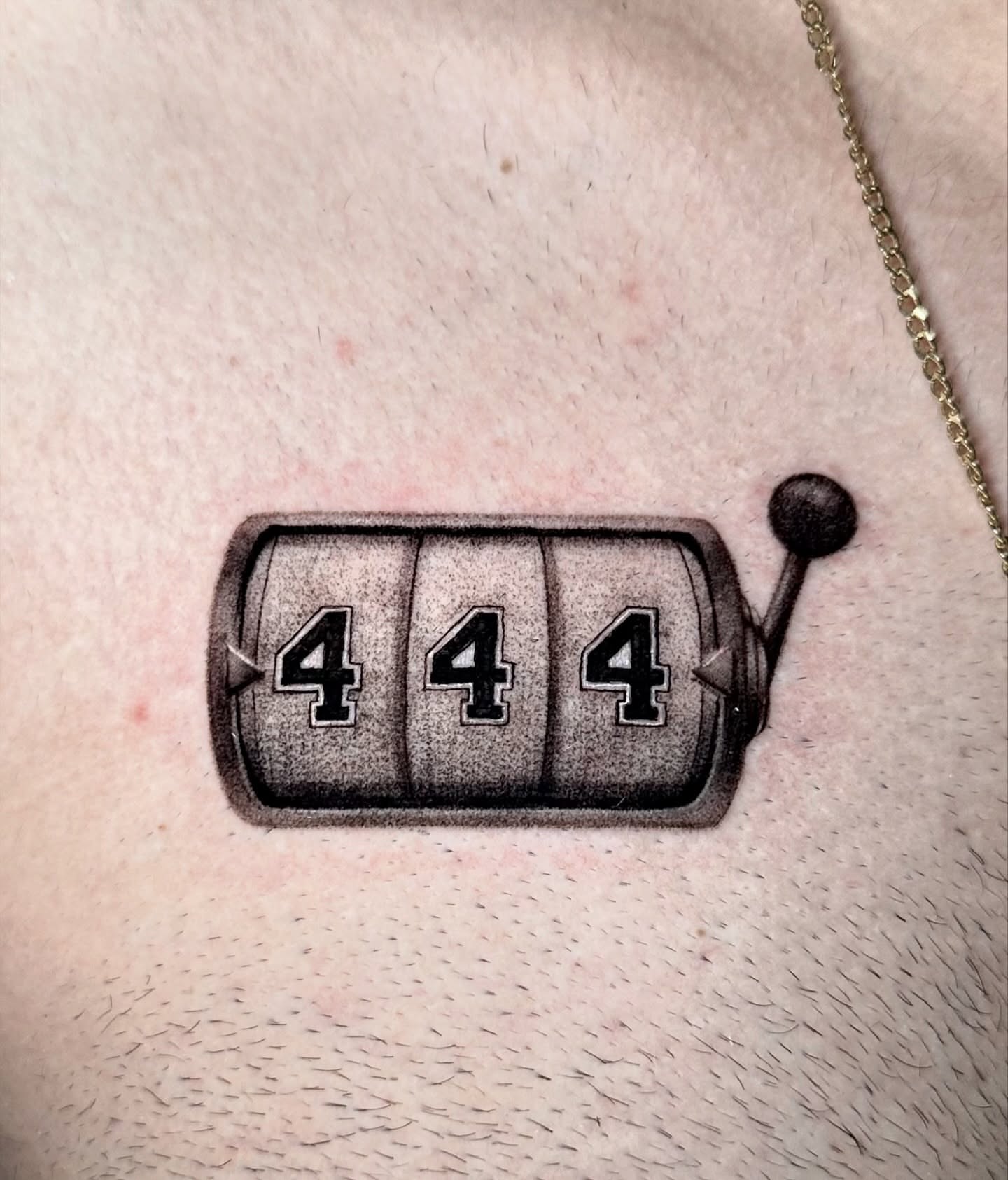 Slot machine realism tattoo on the upper arm by Sophia Delfino