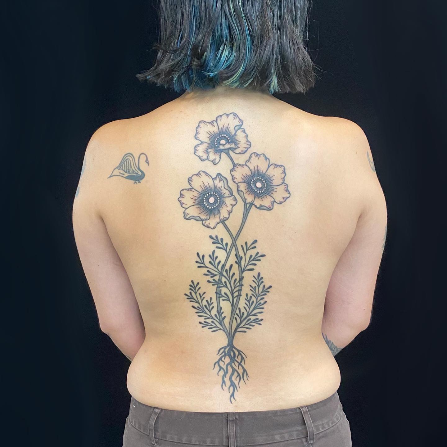 Flowers black and grey tattoo on the back by Krista - Tattoo Artist