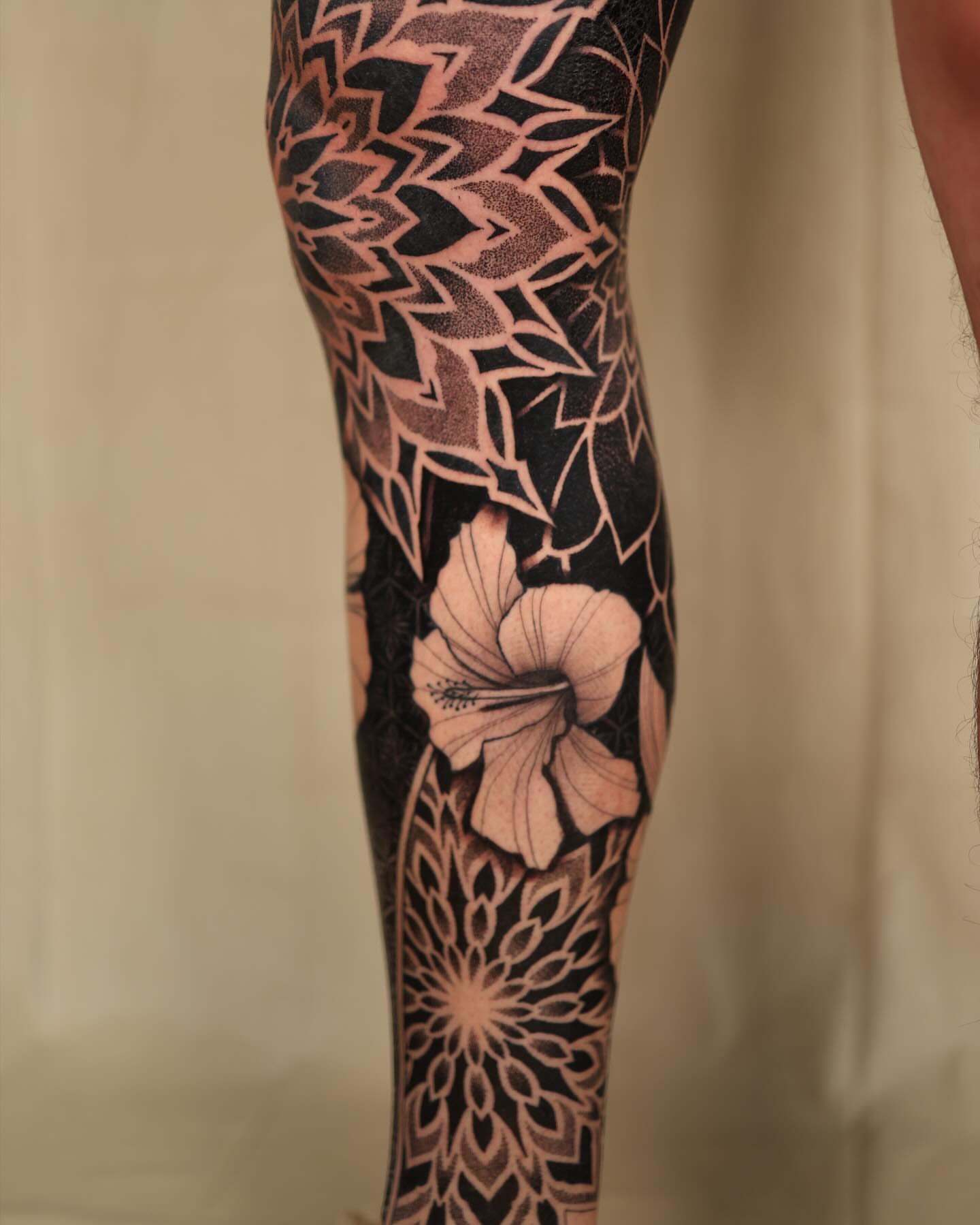 Hawaiian flower dotwork tattoo on the leg by Laure Conzales