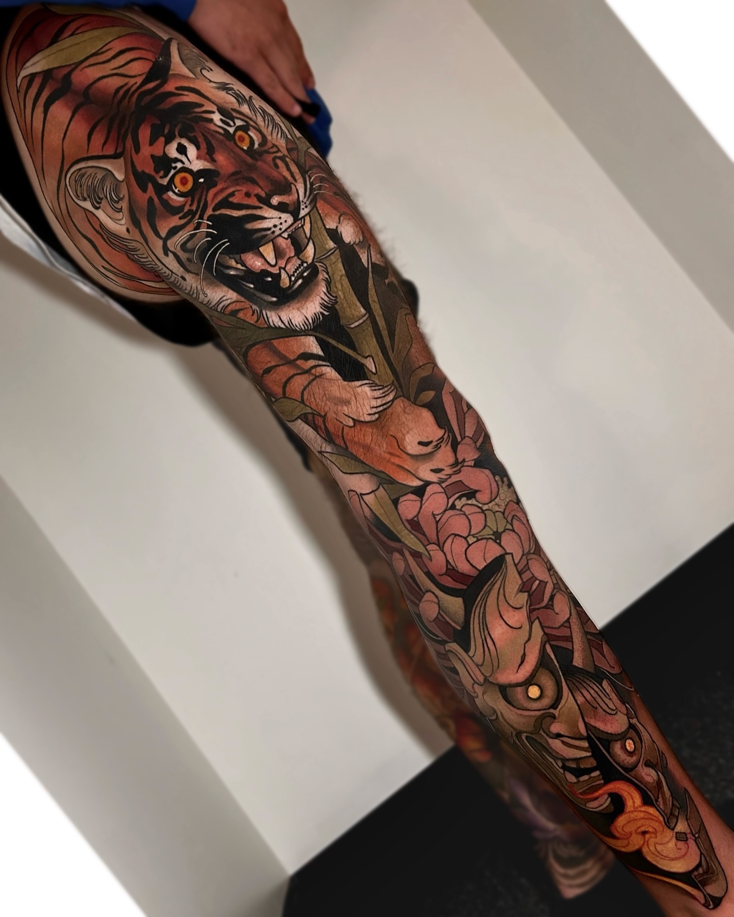 Tiger and mask japanese irezumi tattoo on the forearm by Levi Murphy