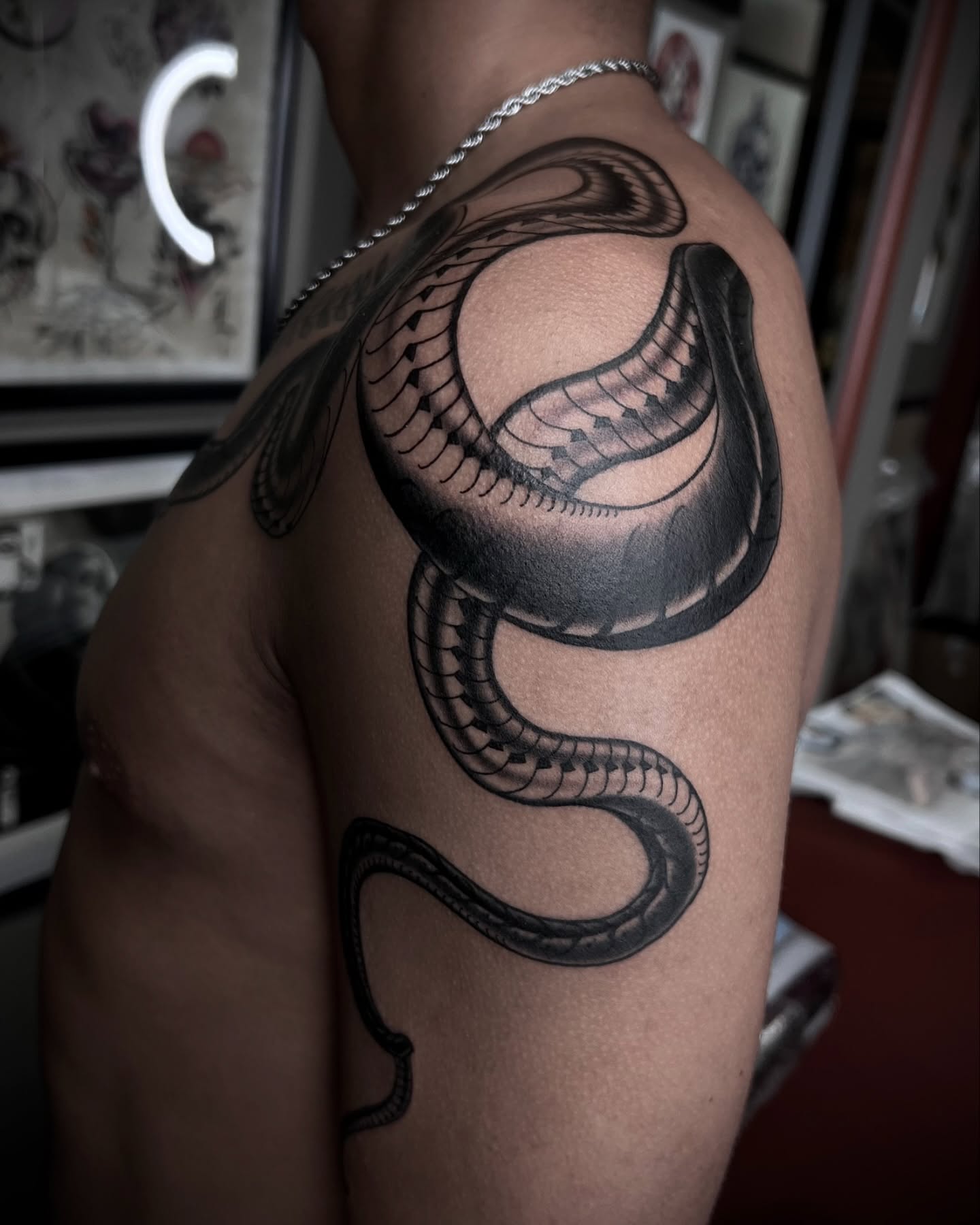 Snake black and grey tattoo on the shoulder by Lorenzo Gomez, San Diego, California