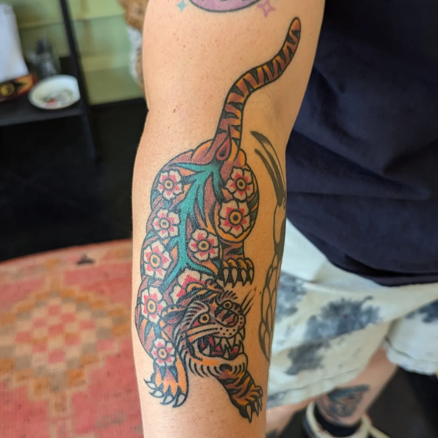 Tiger American traditional tattoo on the forearm by Zack Mueller