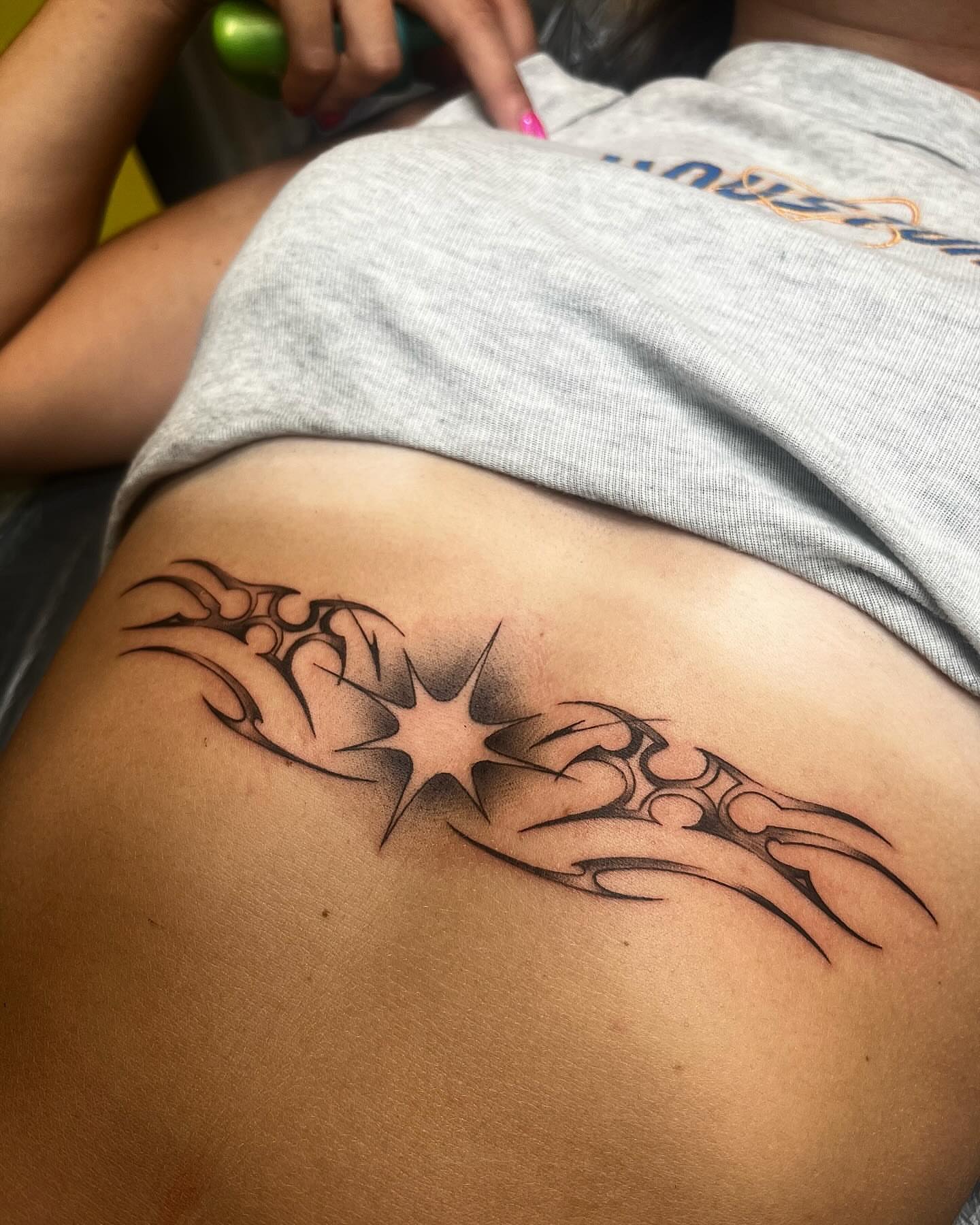 Star with tribal wings tribal tattoo on the ribs by Izzi 🧿 Htx