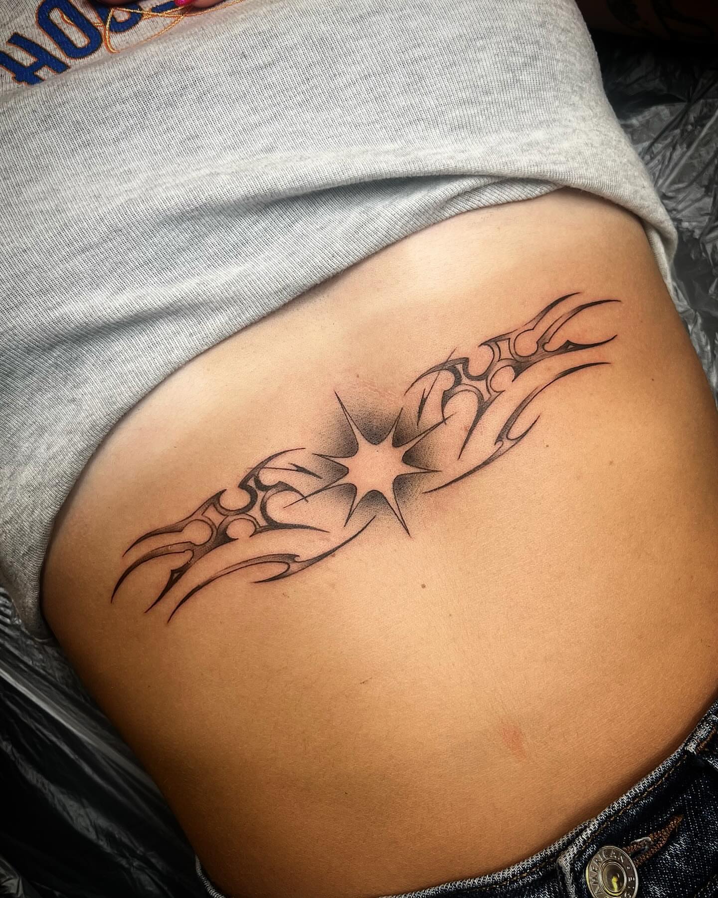 Star with tribal elements tribal tattoo on the ribs by Izzi 🧿 Htx
