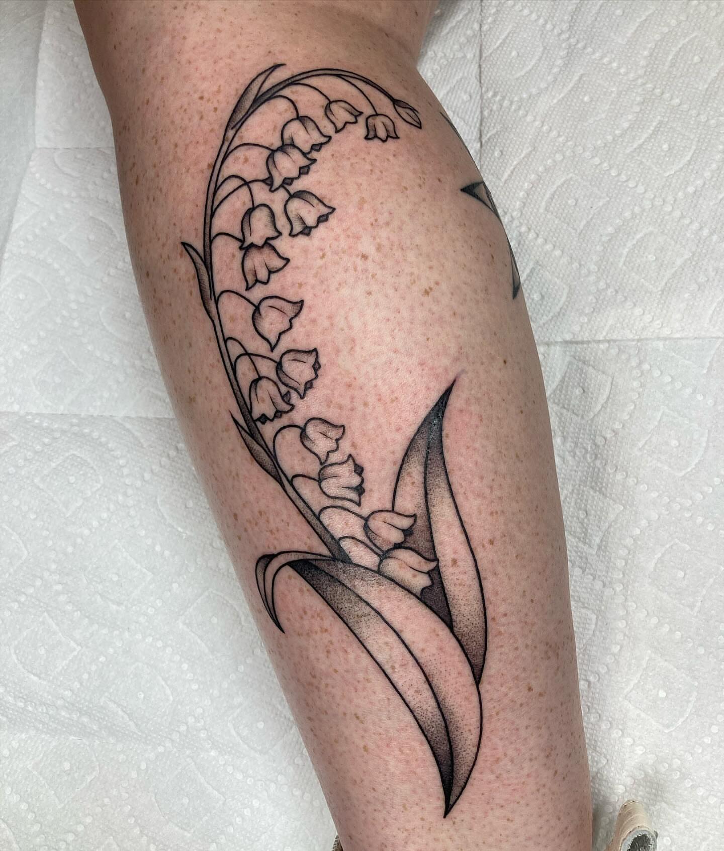 Lily of the valley black and grey tattoo on the forearm by Hali Larkin