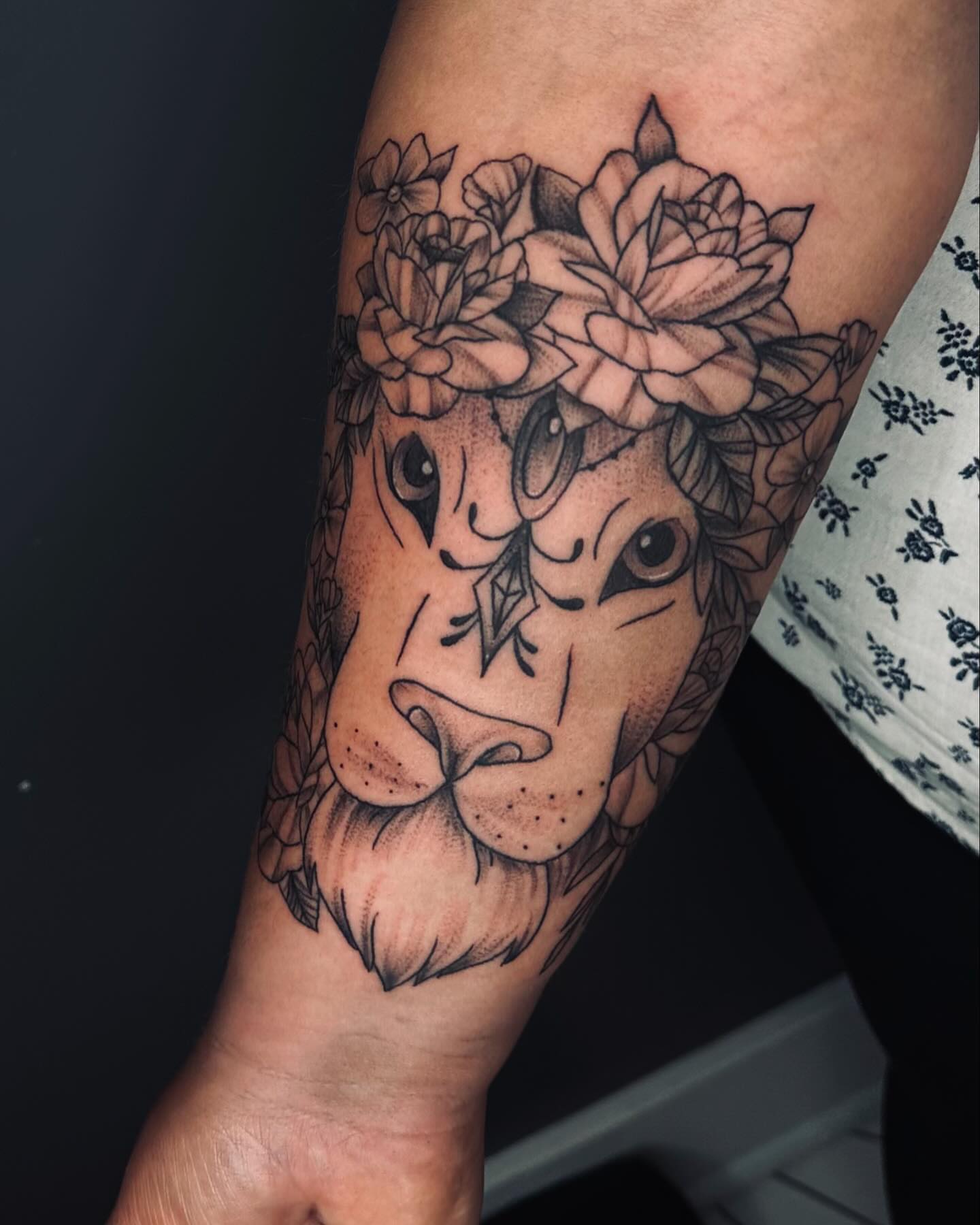 Bull with floral crown realism tattoo on the forearm by Taylor Steckman