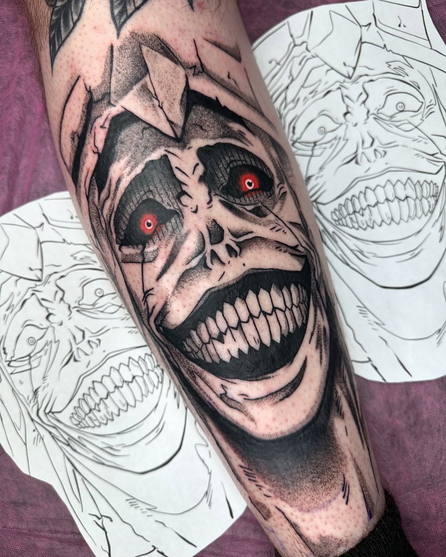 Grinning skull dark realism tattoo on the forearm by Jeremy Thomas