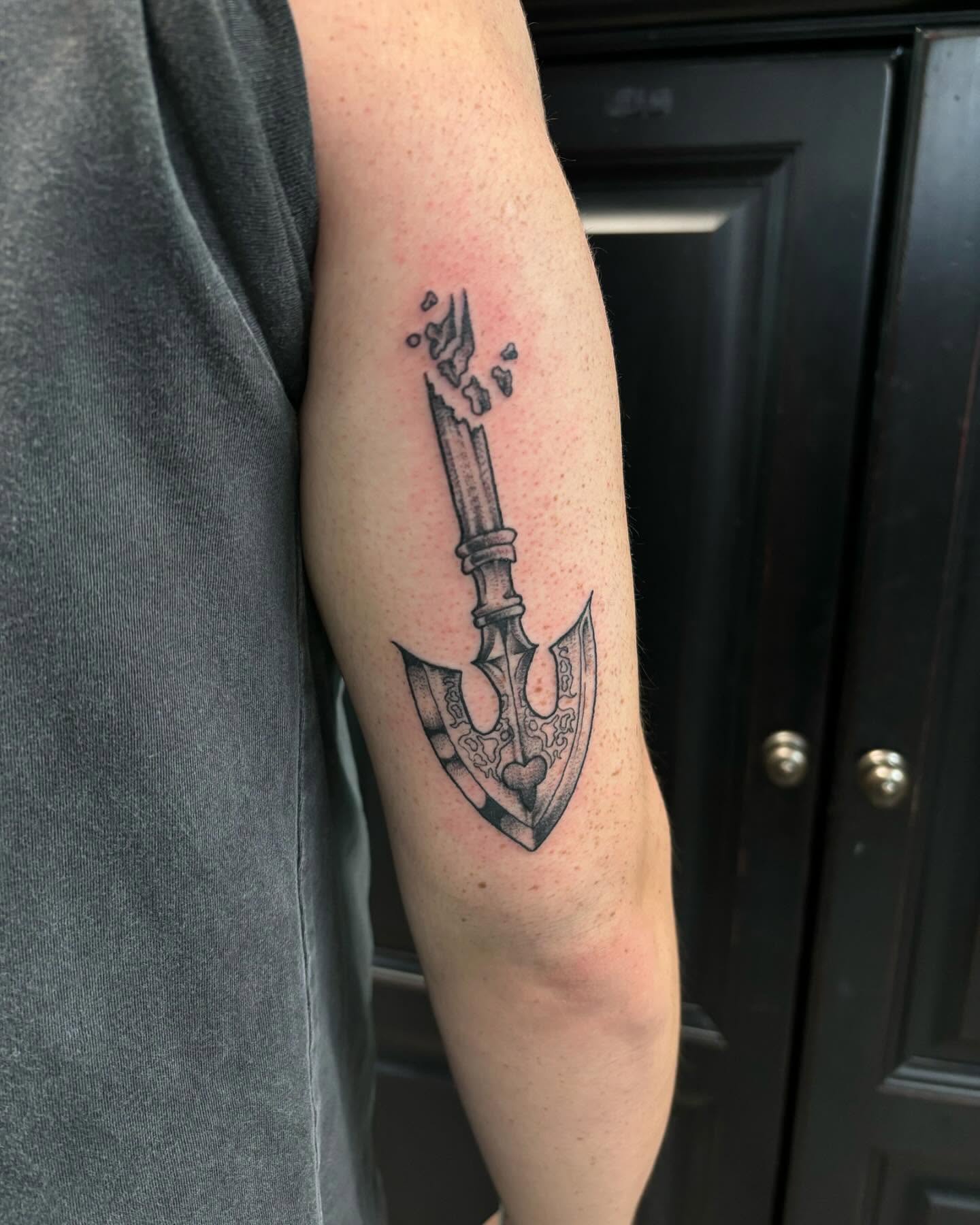 Battle axe black and grey tattoo on the forearm by Ares Rhodes
