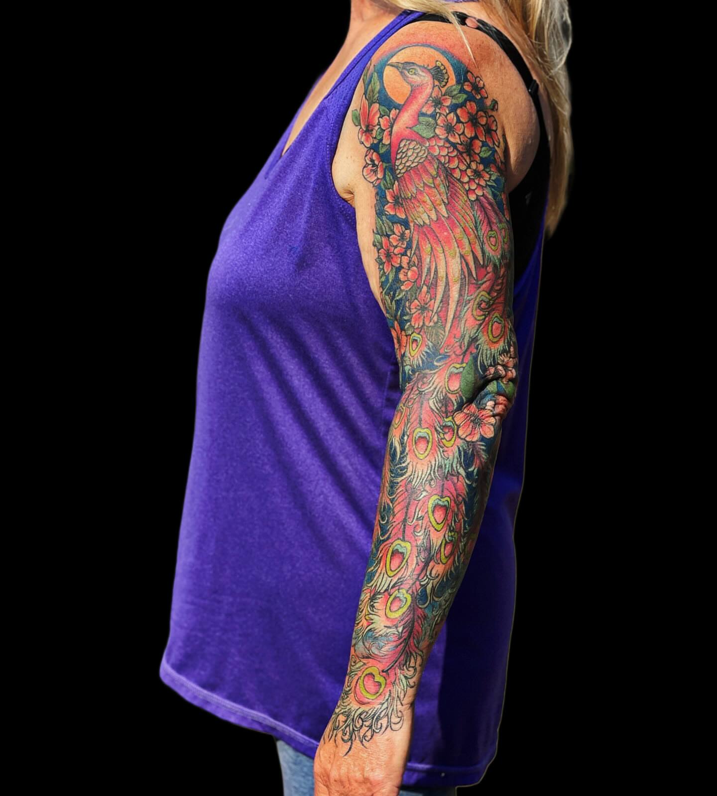 Peacock new school tattoo on the upper arm by Jamie Jane Voryer