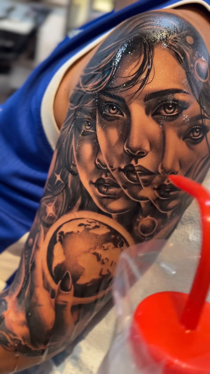 Woman with globe realism tattoo by 𝐉𝐨𝐧 𝐒𝐚𝐧𝐭𝐨𝐬