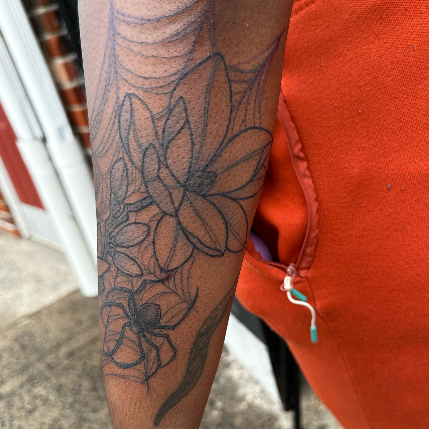 Flower and spider web black and grey tattoo on the forearm by Mia Layne 🤎